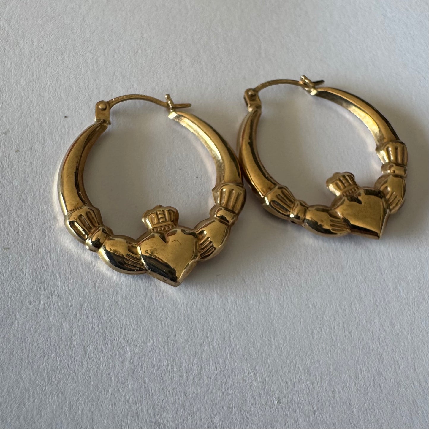 9K gold Claddagh earrings, featuring the iconic Irish motif of a heart held by two hands and topped with a crown, traditionally symbolizing love, friendship and loyalty.