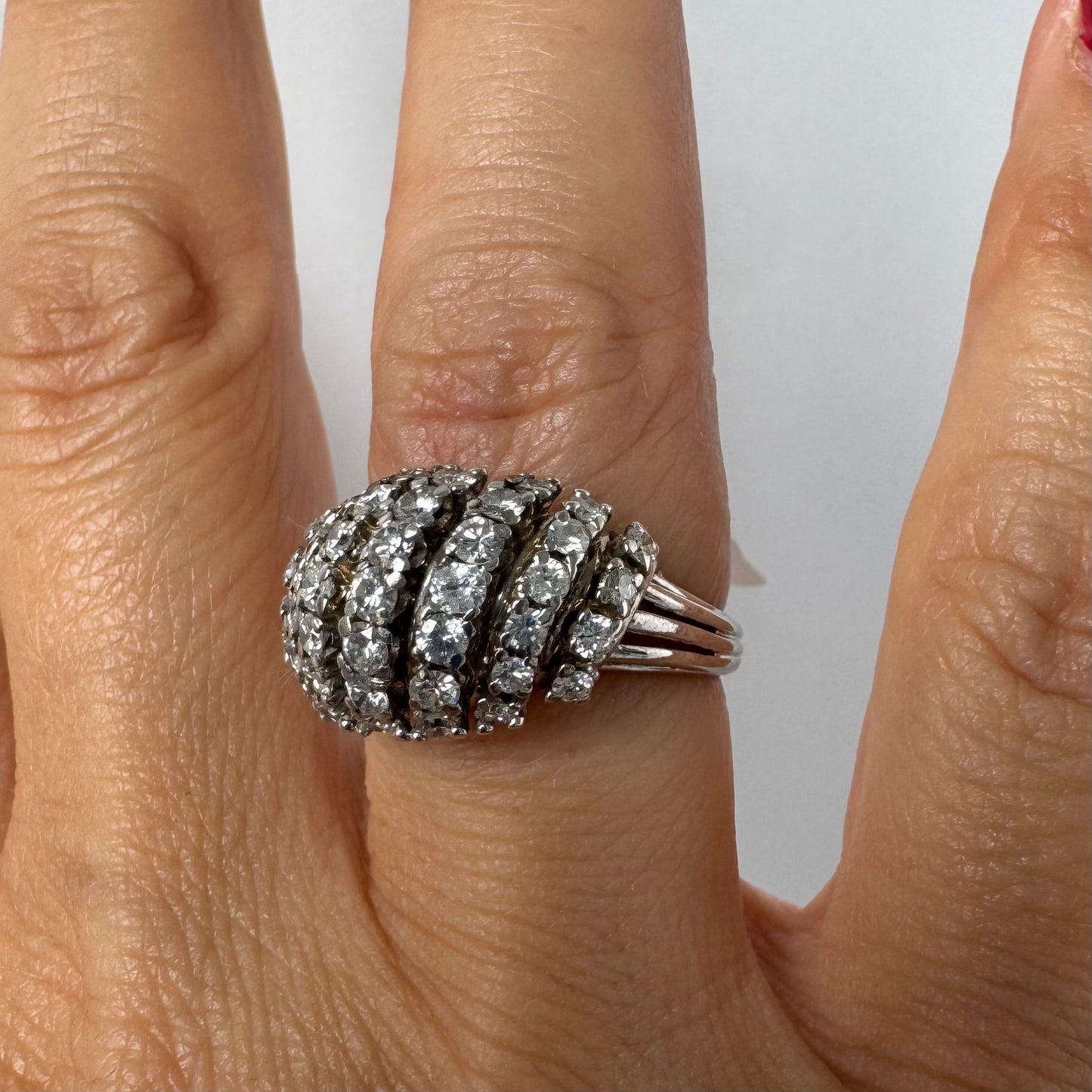 18K gold diamond ring with curved rows of brilliant stones.