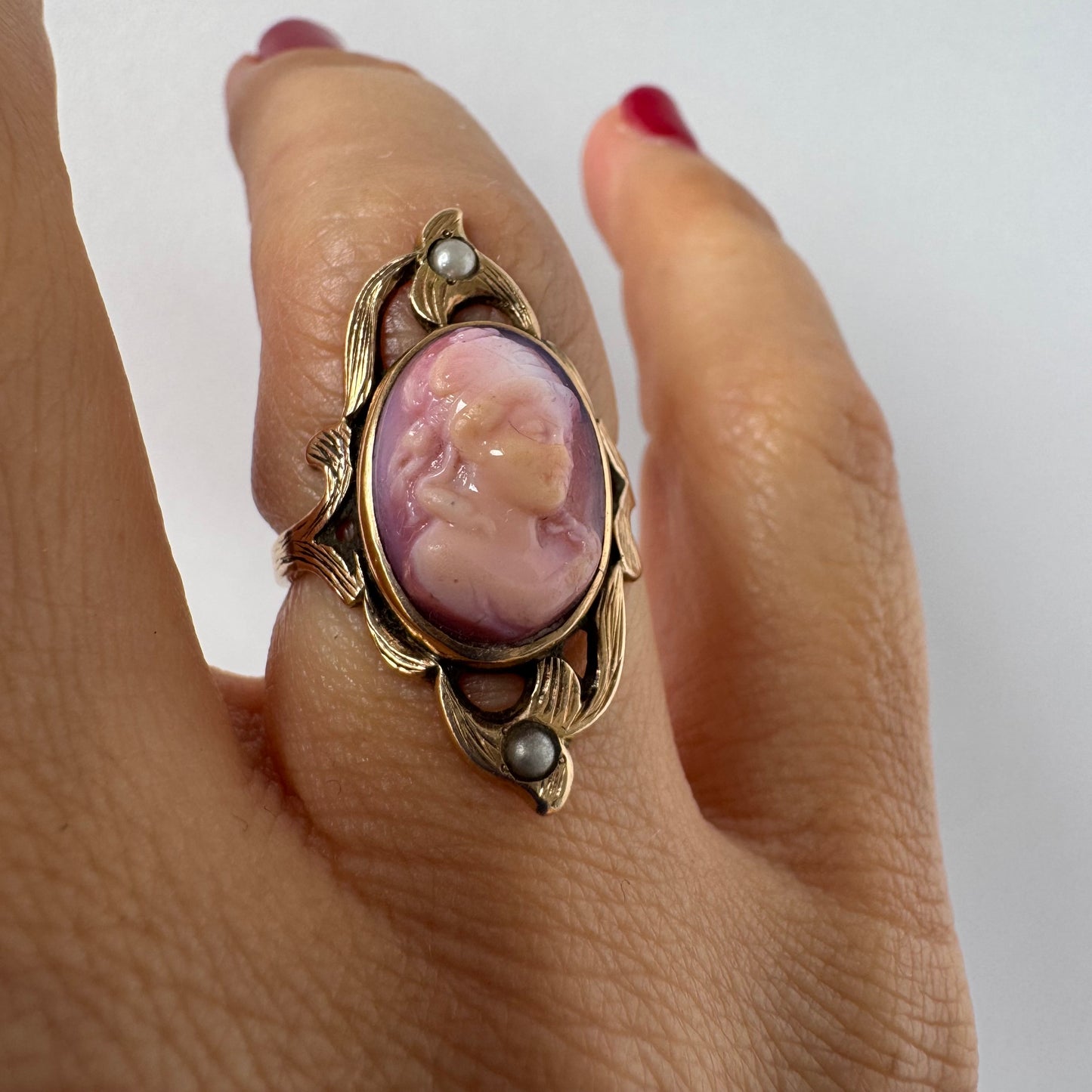 14K gold ring set with a hand-carved pink Cameo, framed by delicate details and accented with small Pearls.