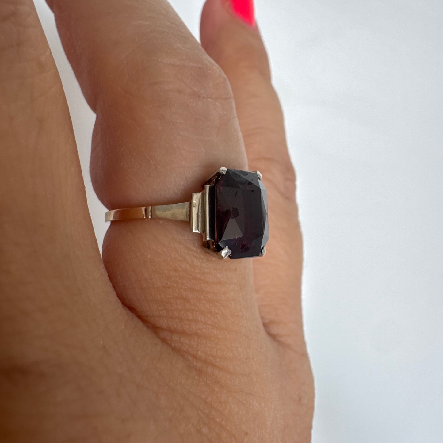 9K gold ring set with a deep burgundy Garnet in an elegant square cut.