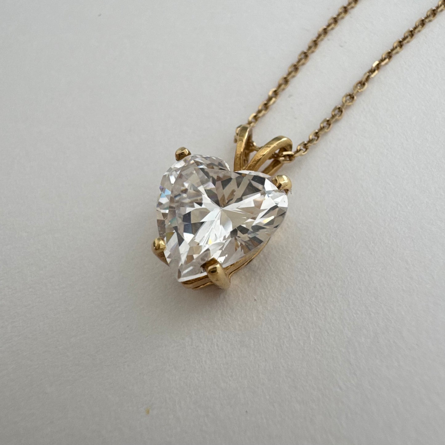 14K gold Heart Pendant set with a brilliant heart-cut clear stone.
