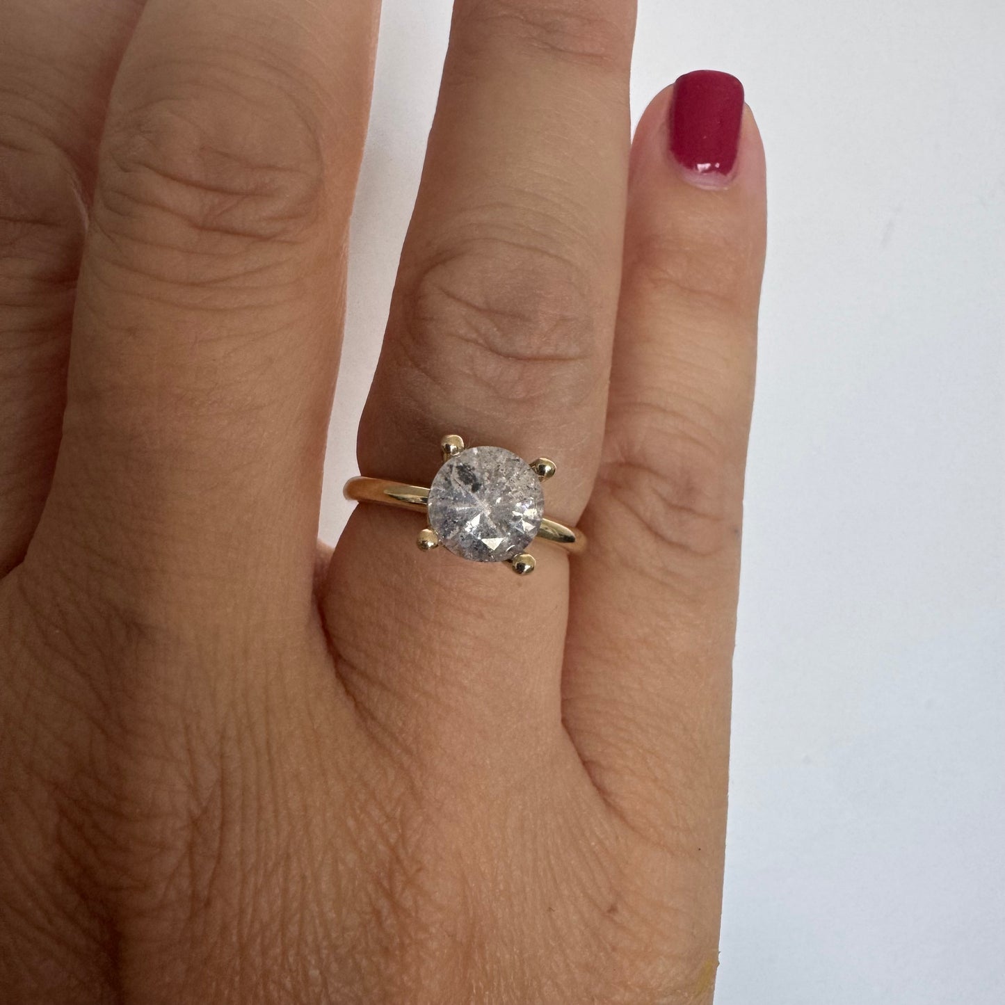14K gold solitaire ring set with a central round Diamond