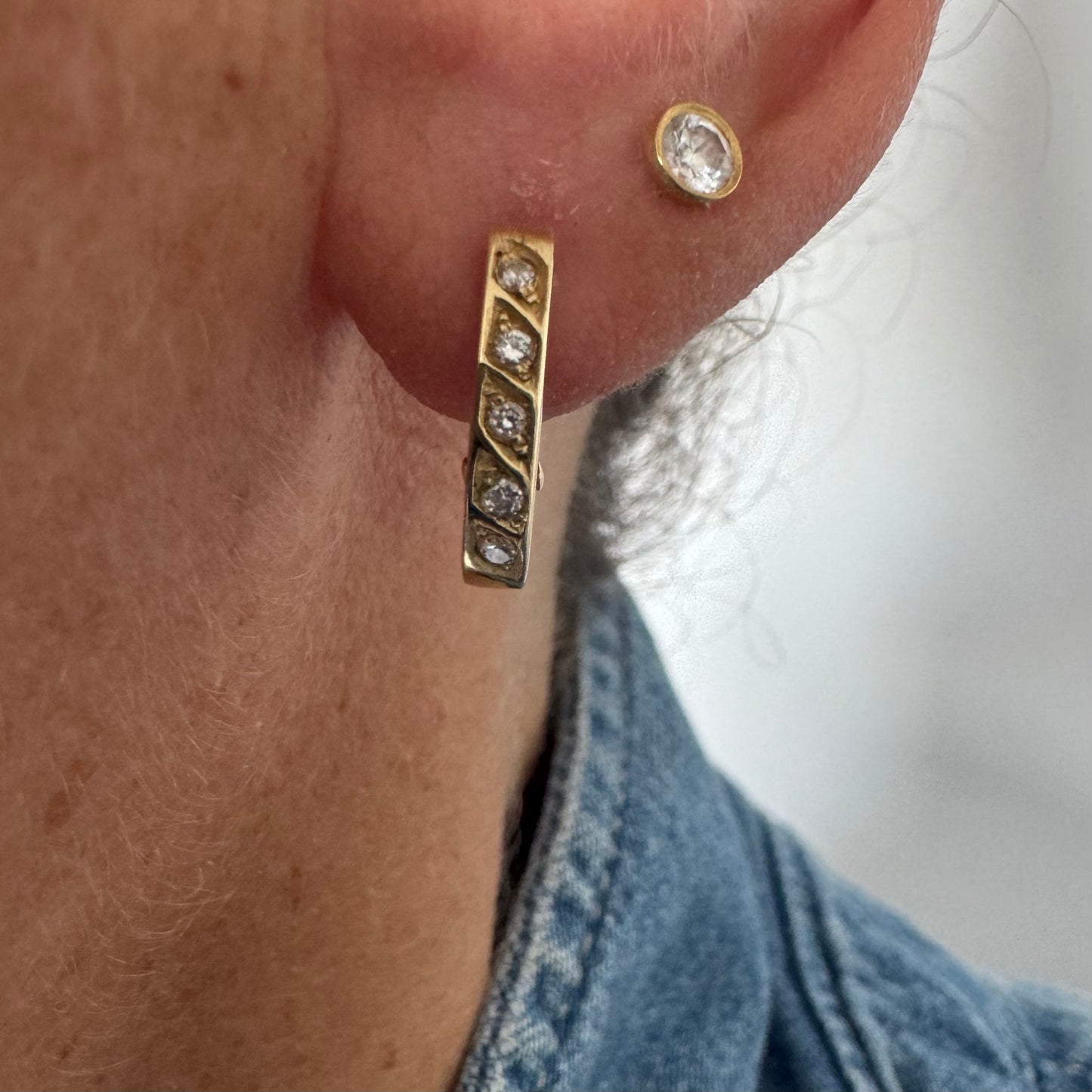 14K gold huggie earrings accented with a delicate row of sparkling Diamonds
