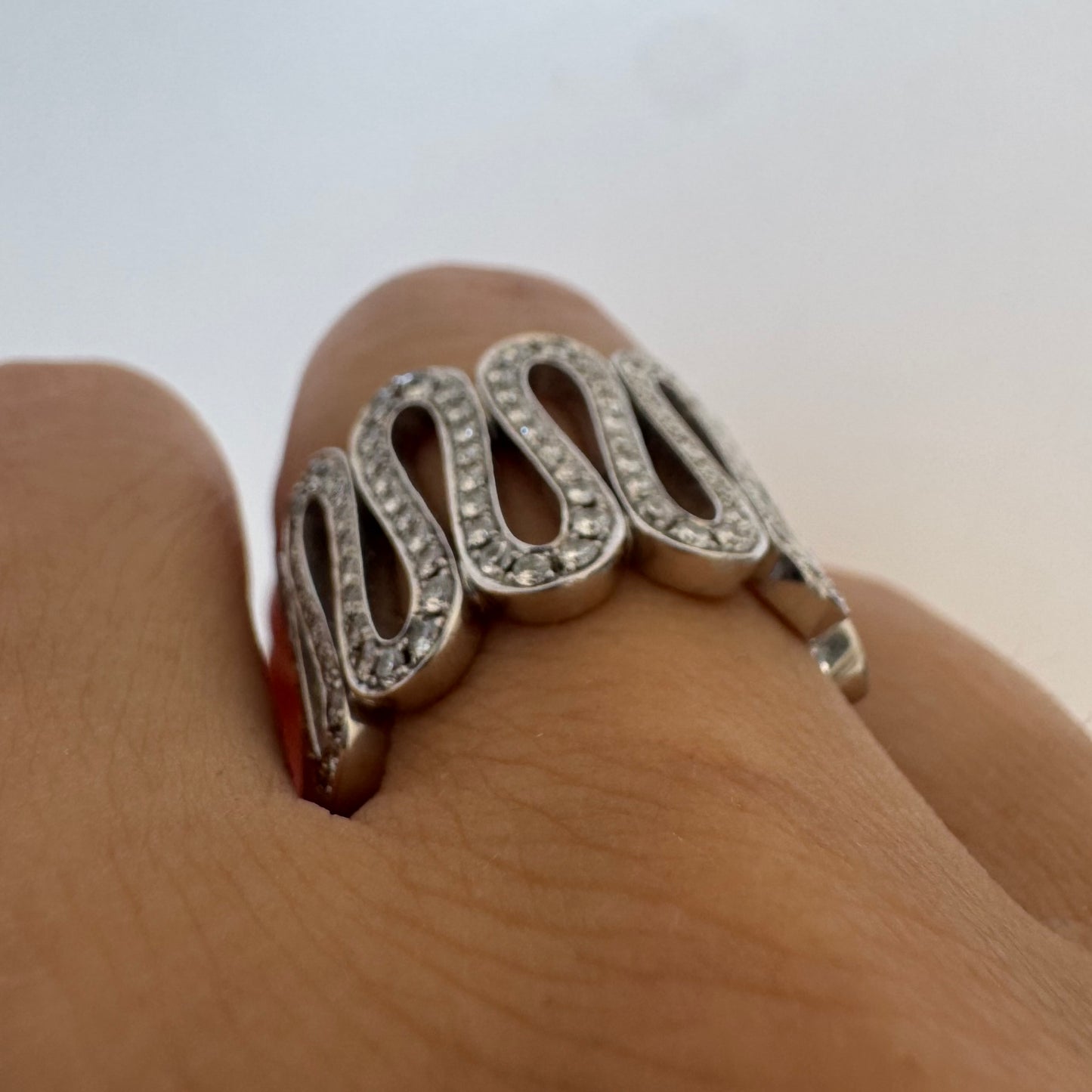 14K gold ring set with shimmering Diamonds in a flowing wave design
