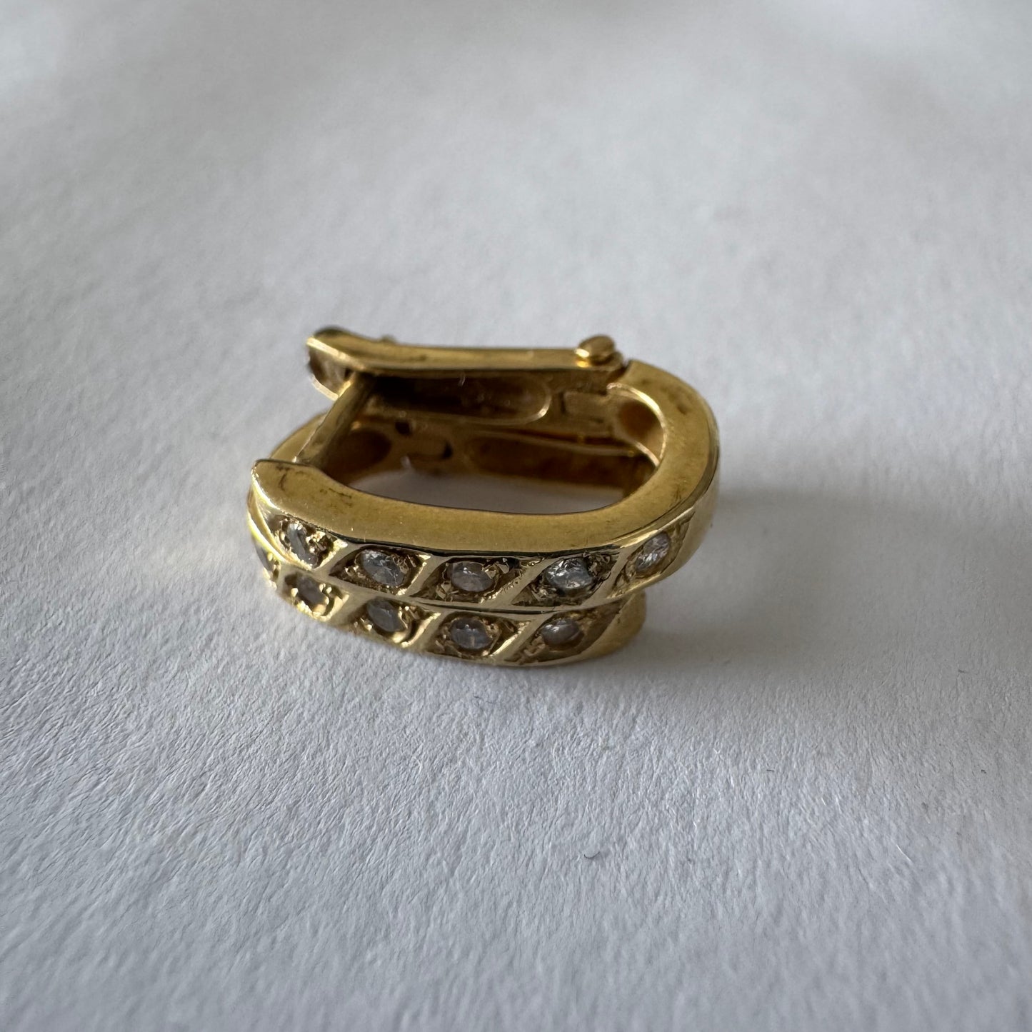 14K gold huggie earrings accented with a delicate row of sparkling Diamonds