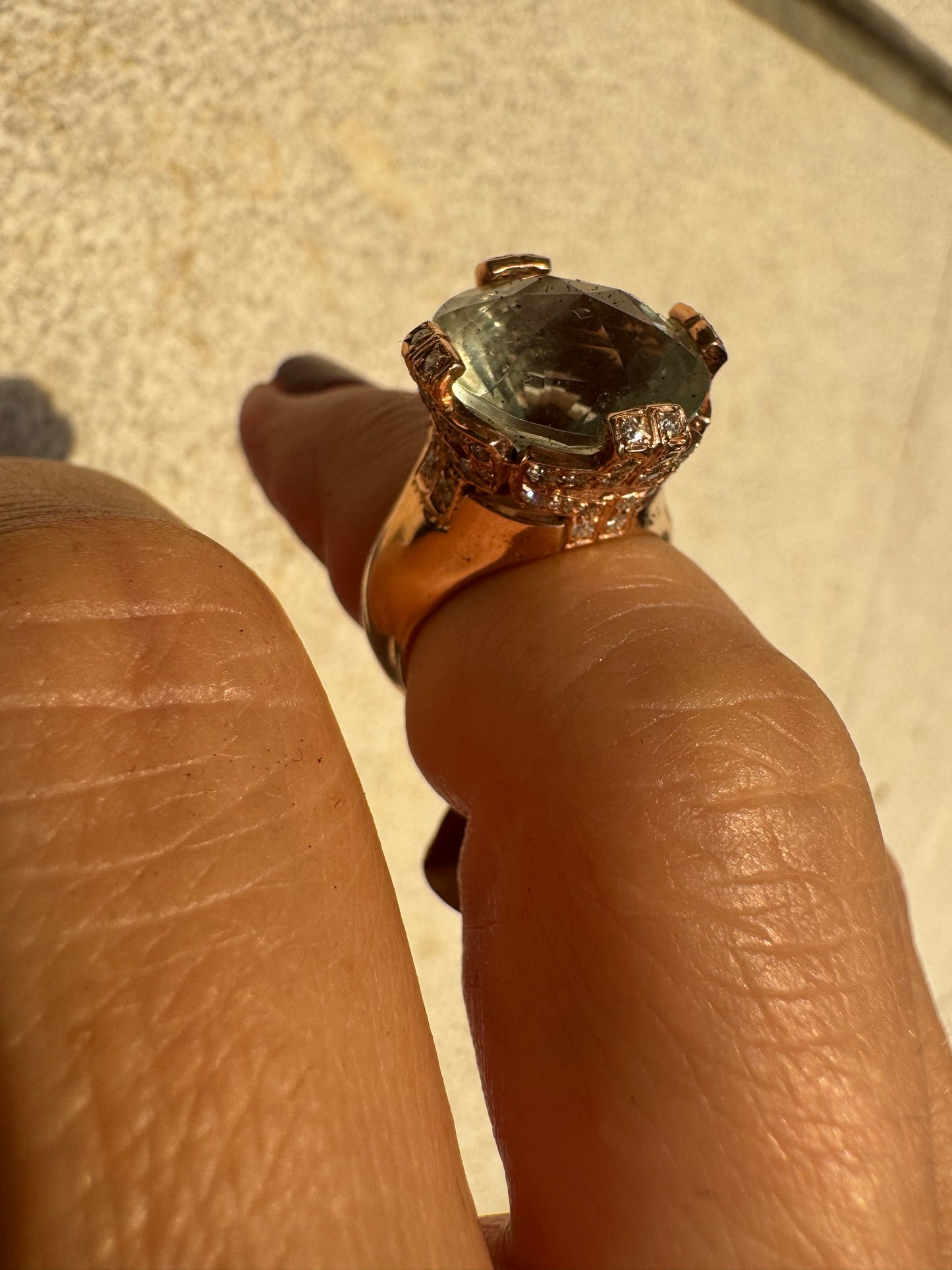 18K gold ring set with a large round Prasiolite gemstone accented by small Diamonds