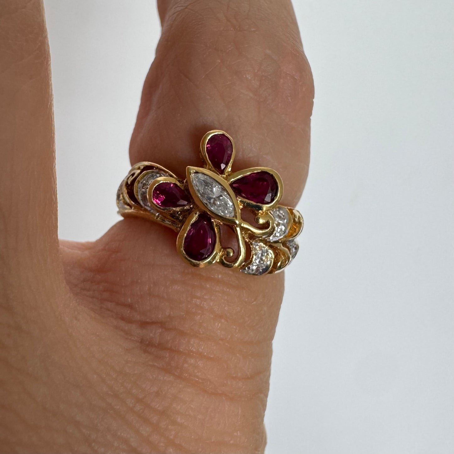 18K gold butterfly ring set with pear-cut Rubies & a marquise-cut Diamond at its center