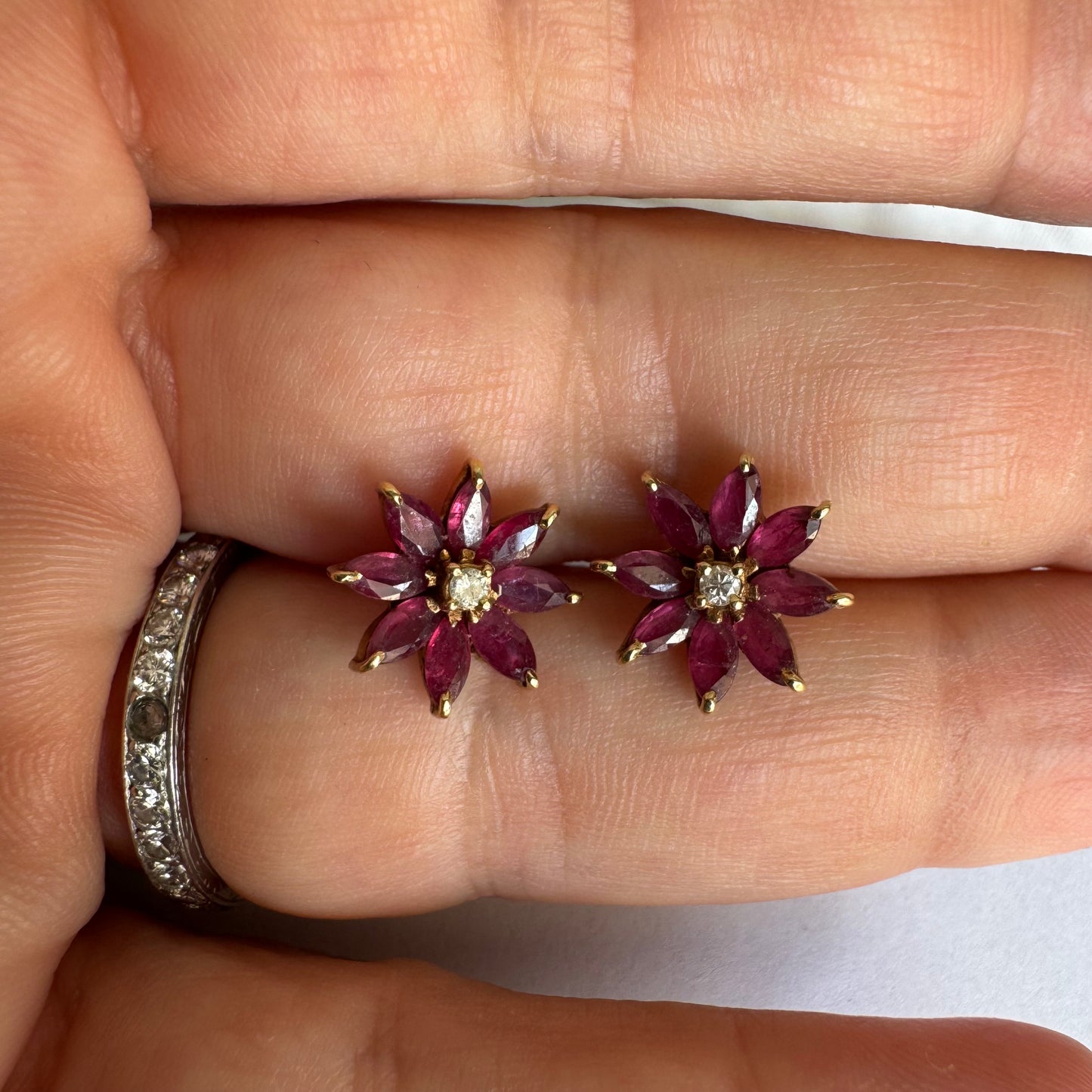 14K gold floral earrings set with marquise-cut Rubies and a small Diamond at the center