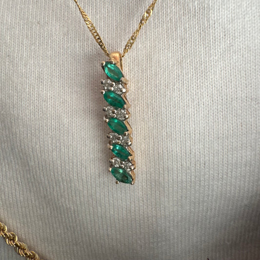 14K gold pendant set with marquise-cut Emeralds and sparkling Diamonds.
