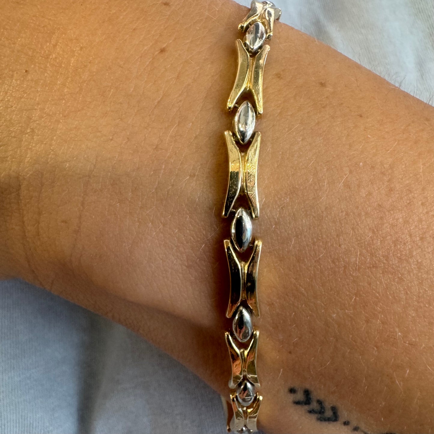 14K gold bracelet featuring a bold geometric design with X-shaped