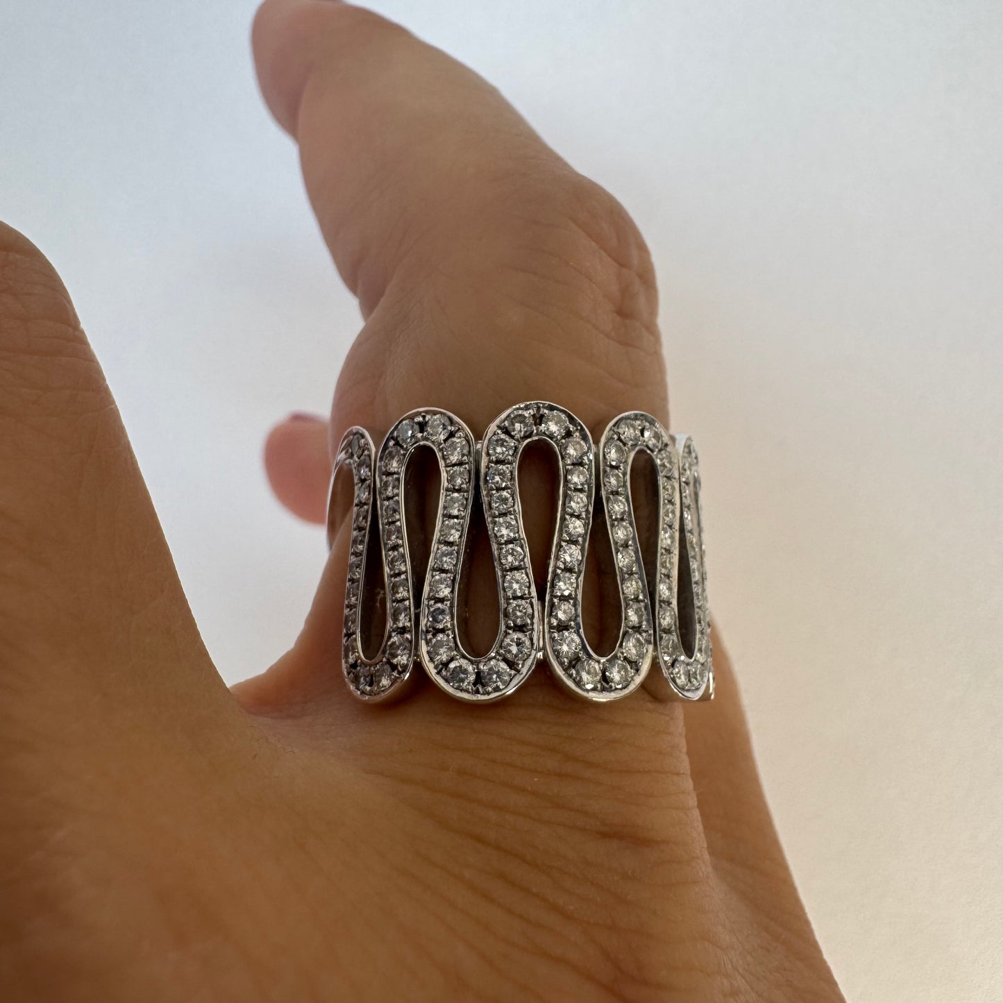 14K gold ring set with shimmering Diamonds in a flowing wave design