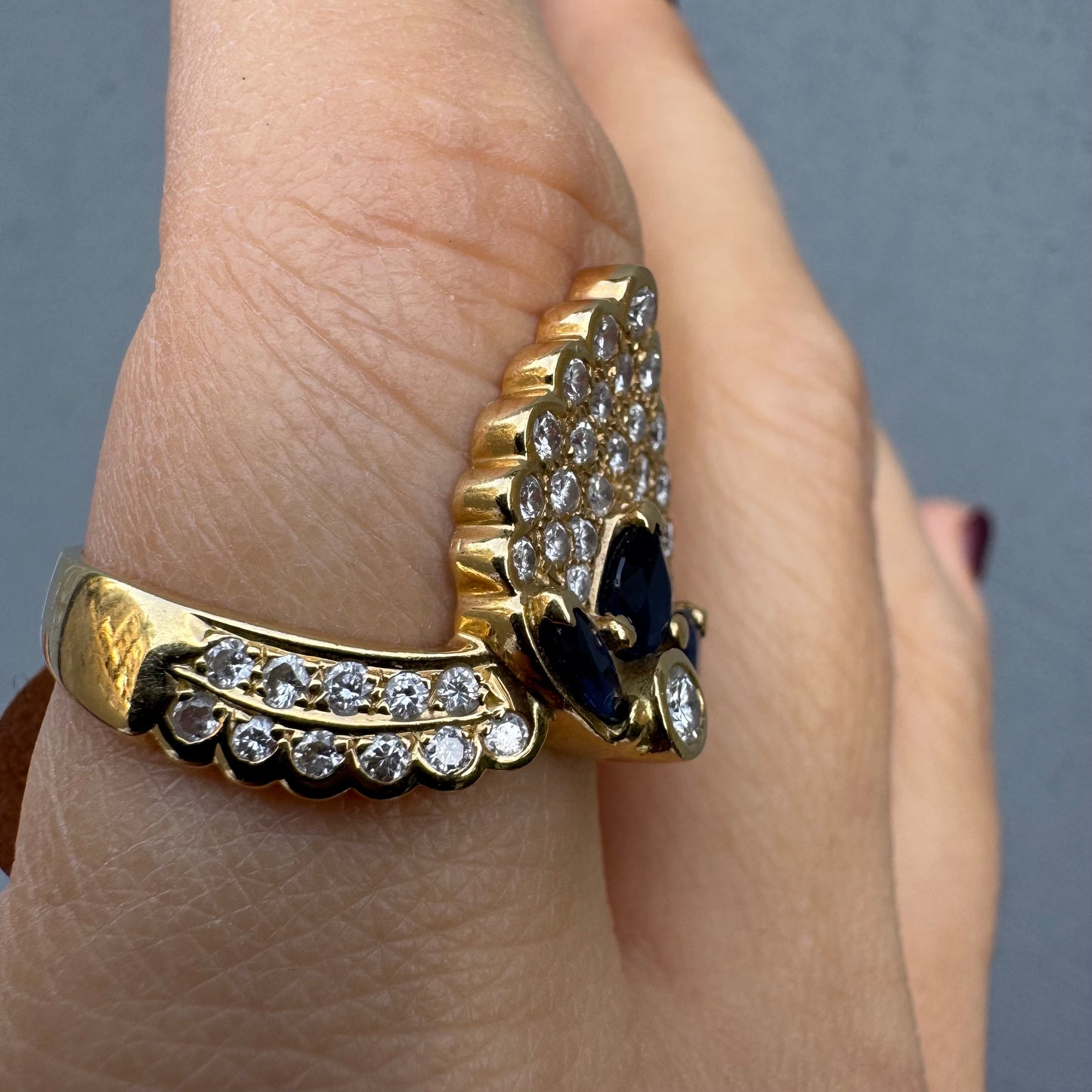 18K gold ring set with Diamonds and deep blue Sapphires, designed to make a true statement.