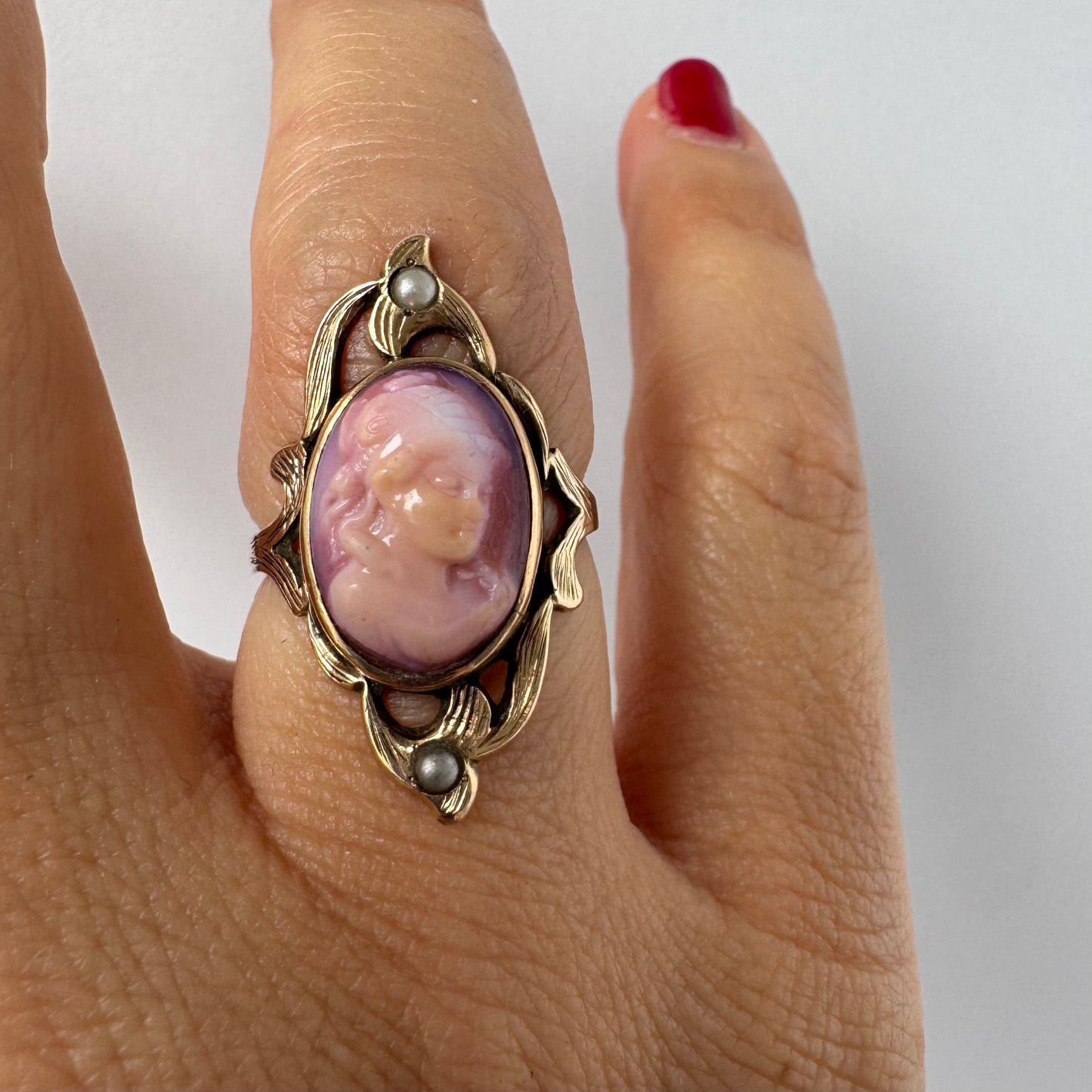 14K gold ring set with a hand-carved pink Cameo, framed by delicate details and accented with small Pearls.