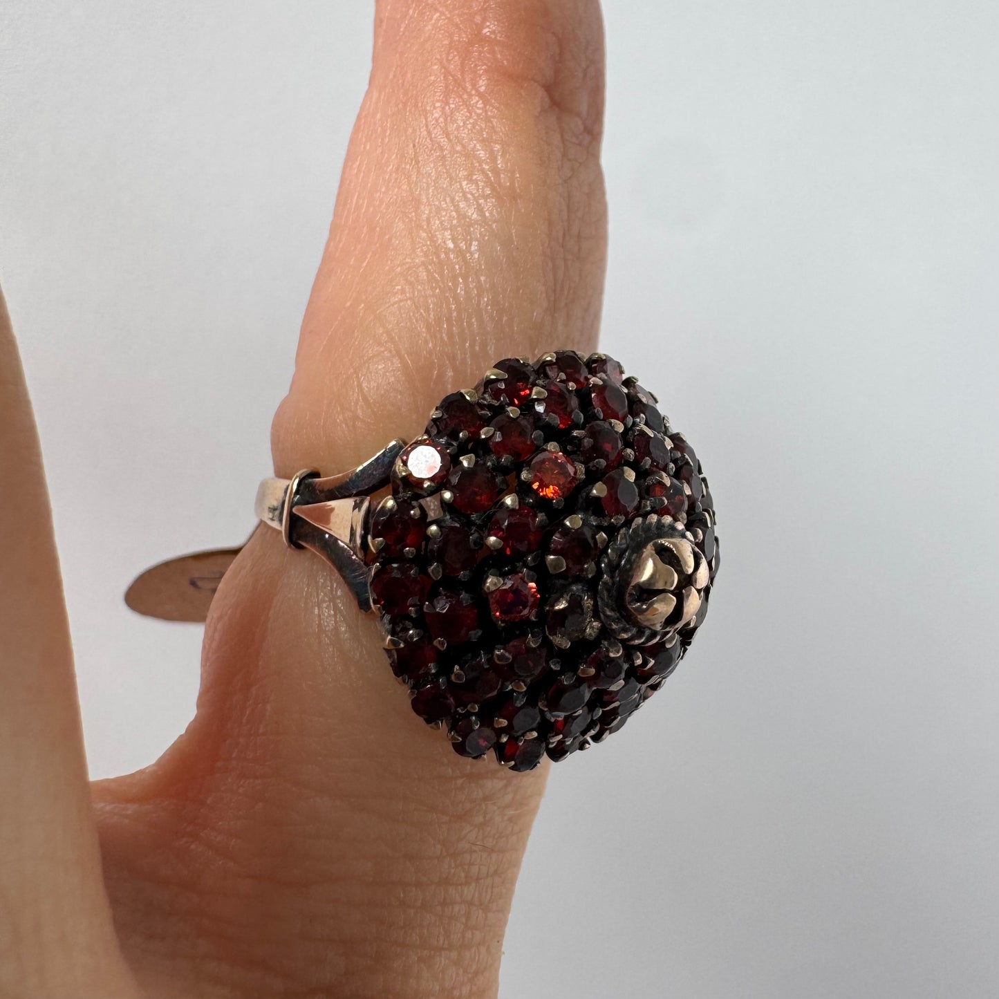 10K gold statement ring designed as a bold floral cluster set with Garnets