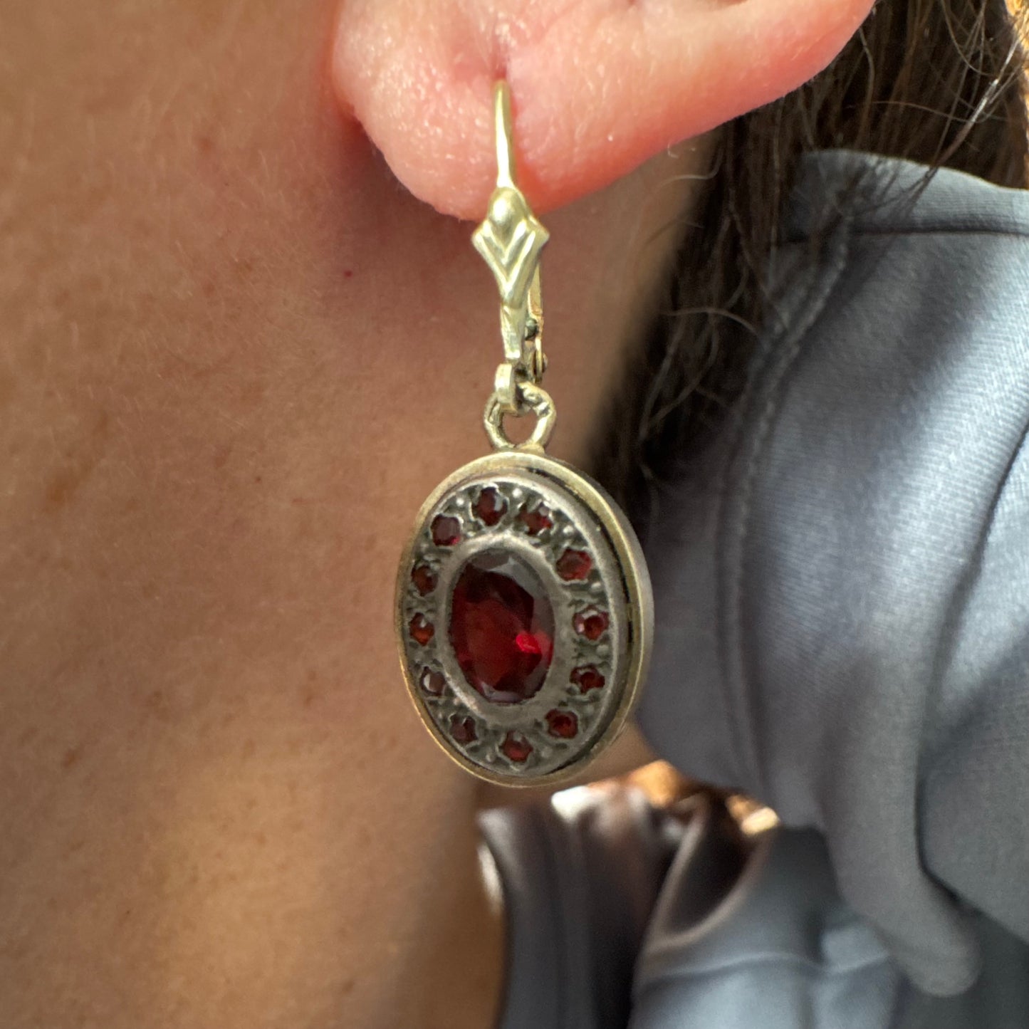 14K gold drop earrings set with deep red oval Garnets surrounded by smaller stones Garnets.