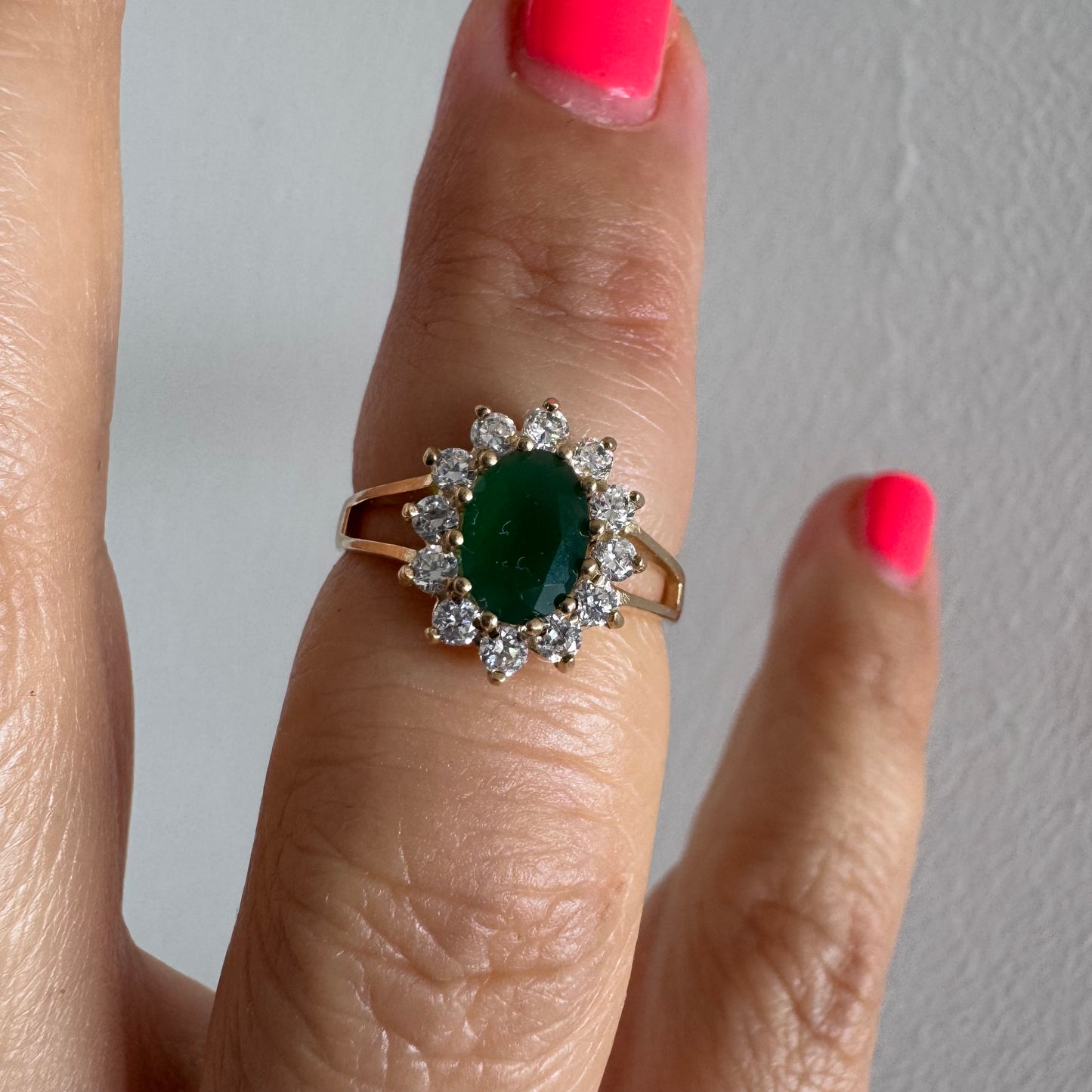 9K gold ring set with a striking green Emerald in a timeless classic design.