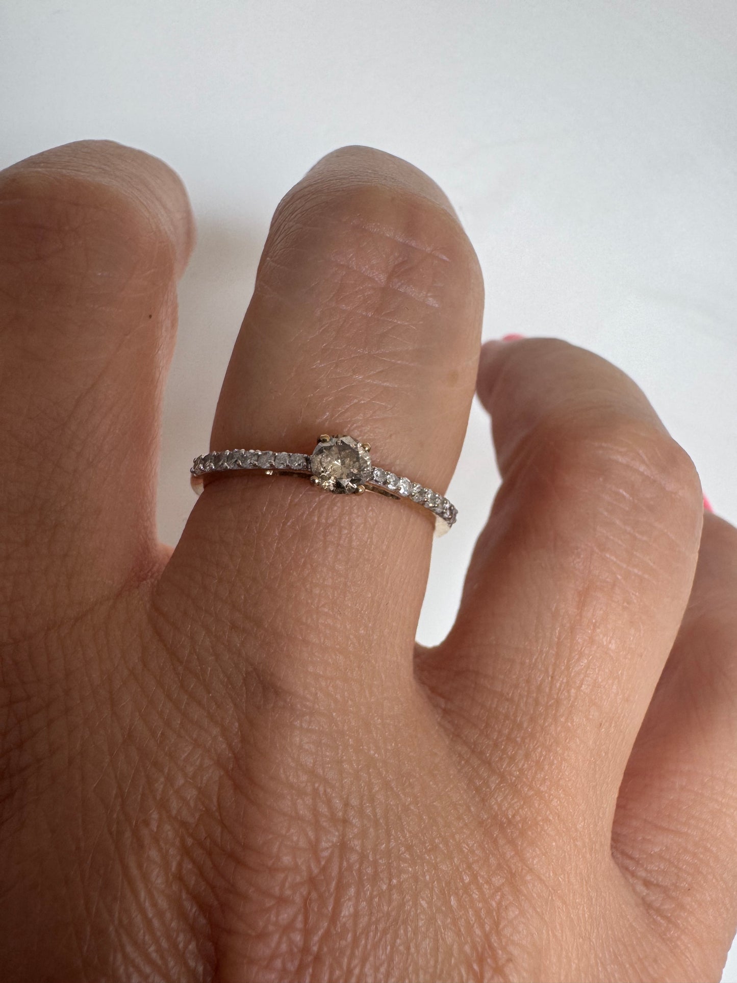 9K gold ring set with a central Diamond and sparkling Diamonds along the band