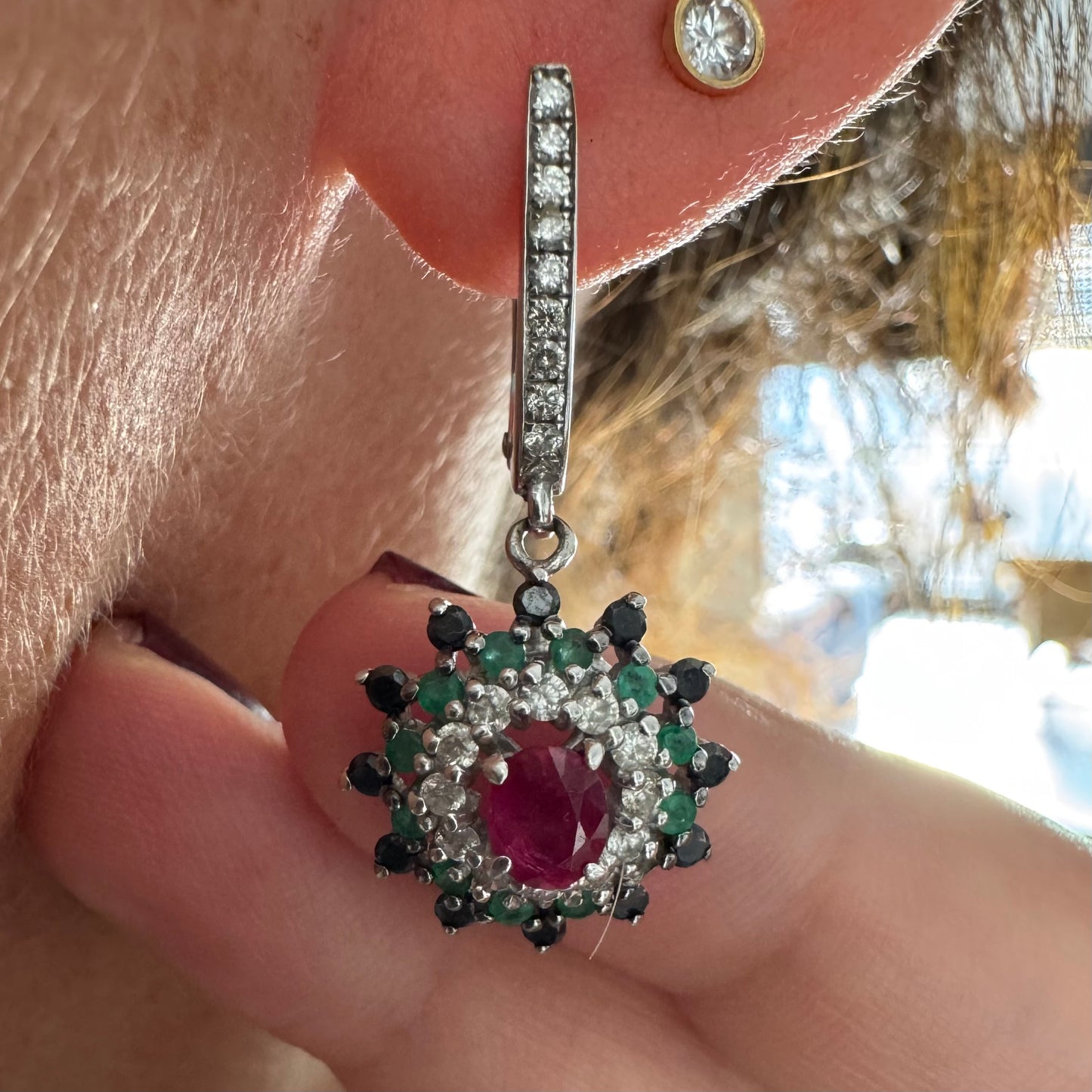 14K white gold drop earrings set with white and black Diamonds, Emeralds and a central Ruby