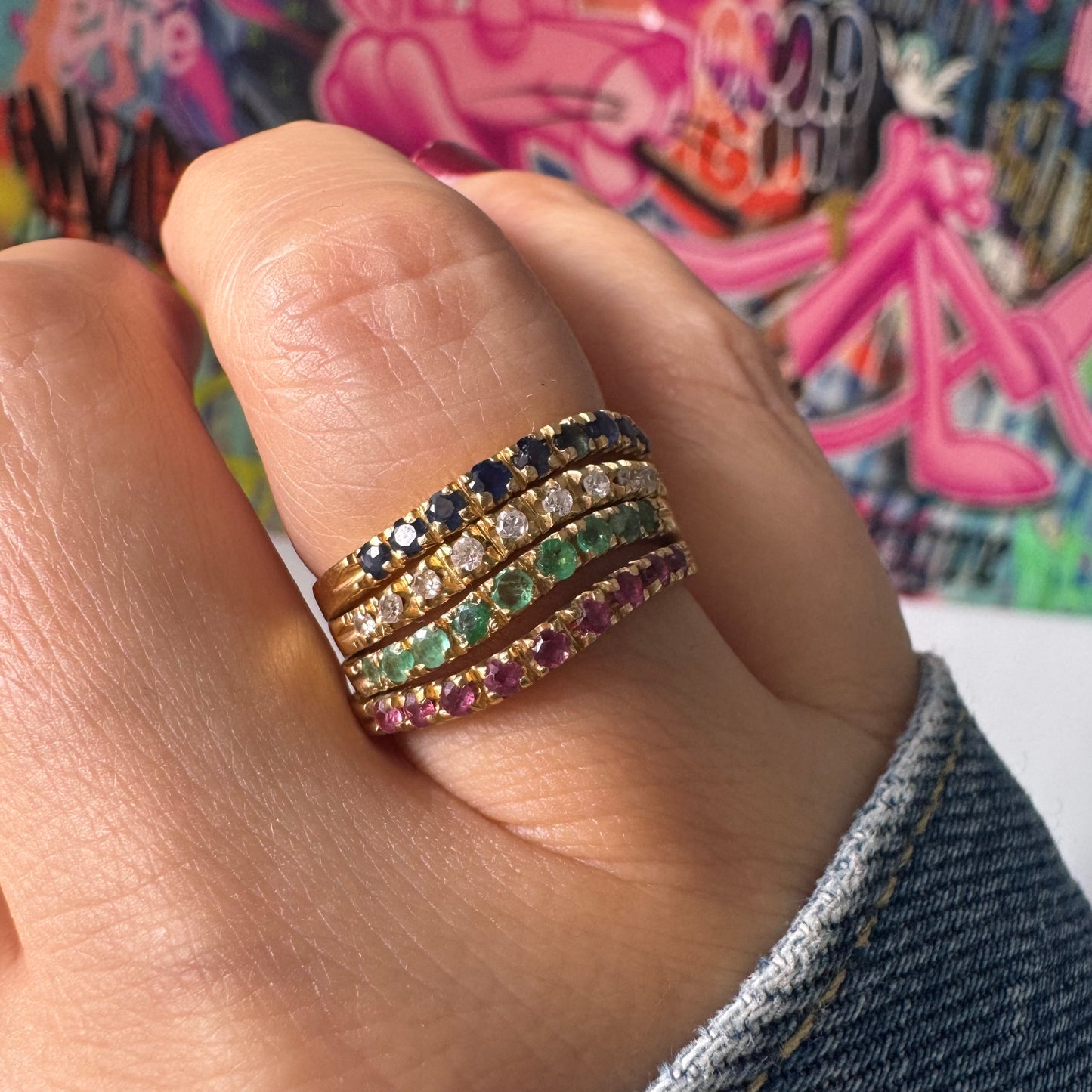 18K yellow gold ring set with vibrant rows of Sapphires, Emeralds, Rubies, and Diamonds