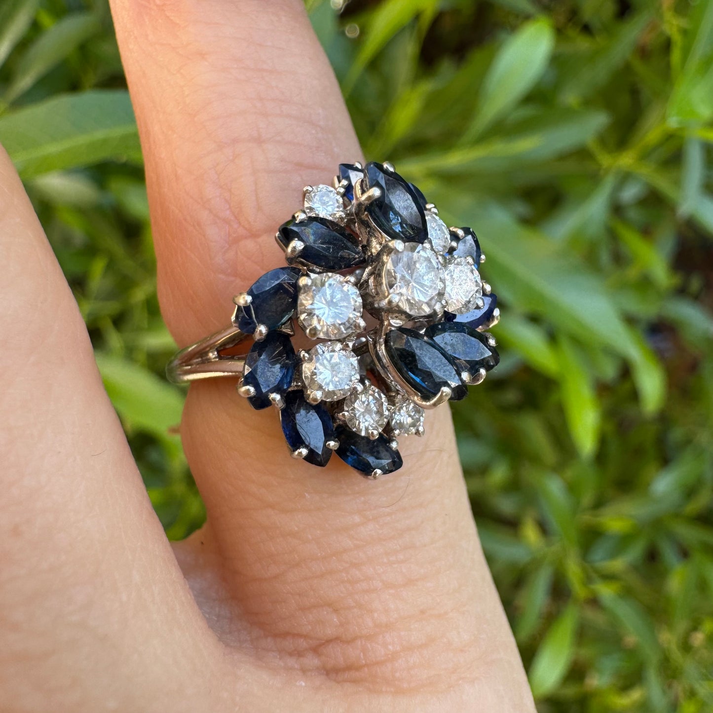18K white gold ring, set with marquise-cut blue Sapphires and round Diamonds, in a classic cluster design.