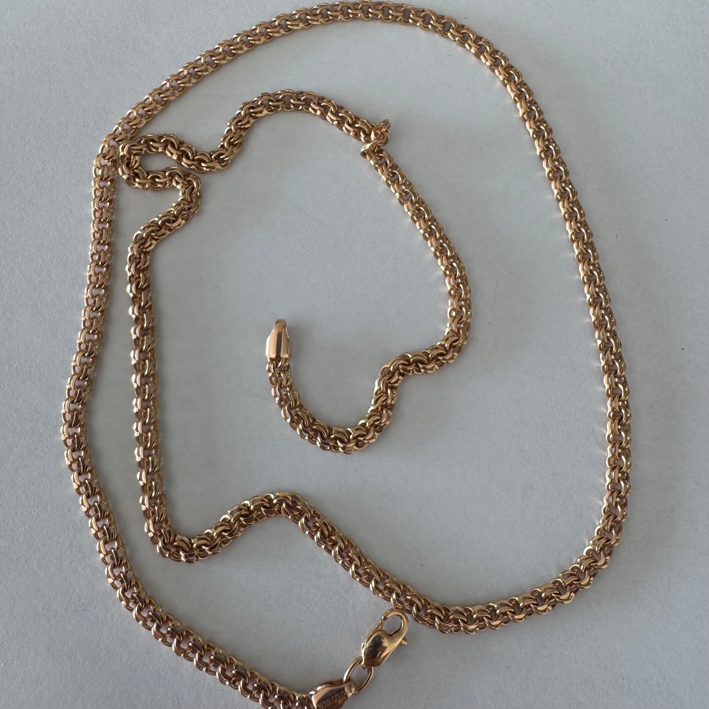 14K gold chain featuring an intricate woven link