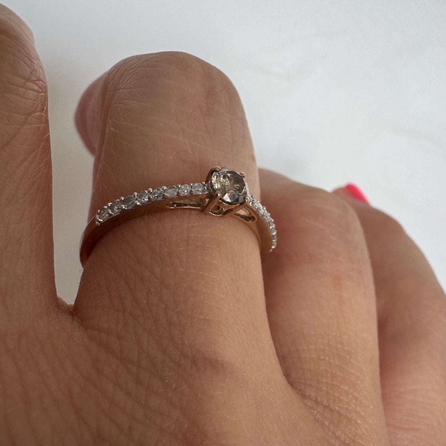 9K gold ring set with a central Diamond and sparkling Diamonds along the band
