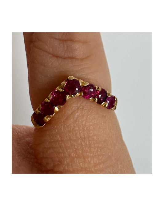 18K gold ring set with a row of rich red Rubies.