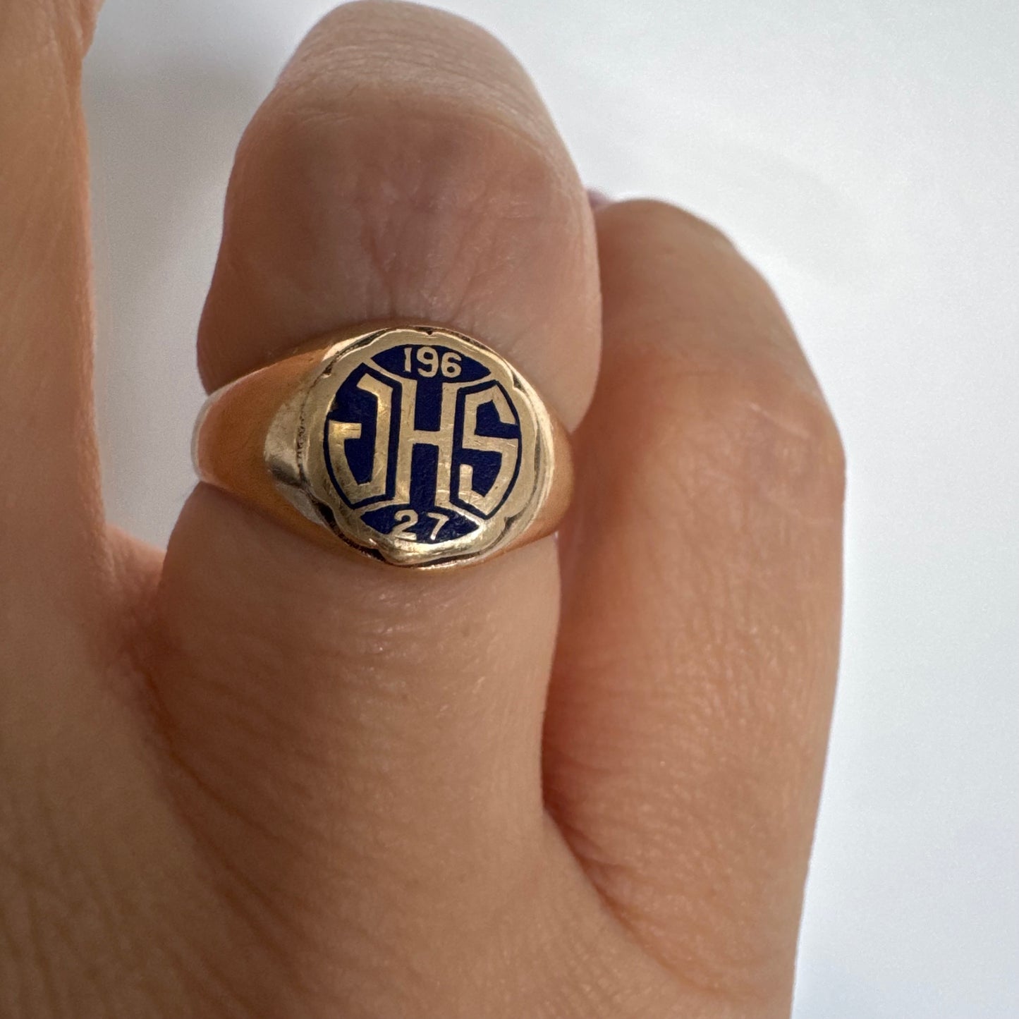 14K gold signet ring featuring an oval face with dark enamel and bold engraved initials at the center.
