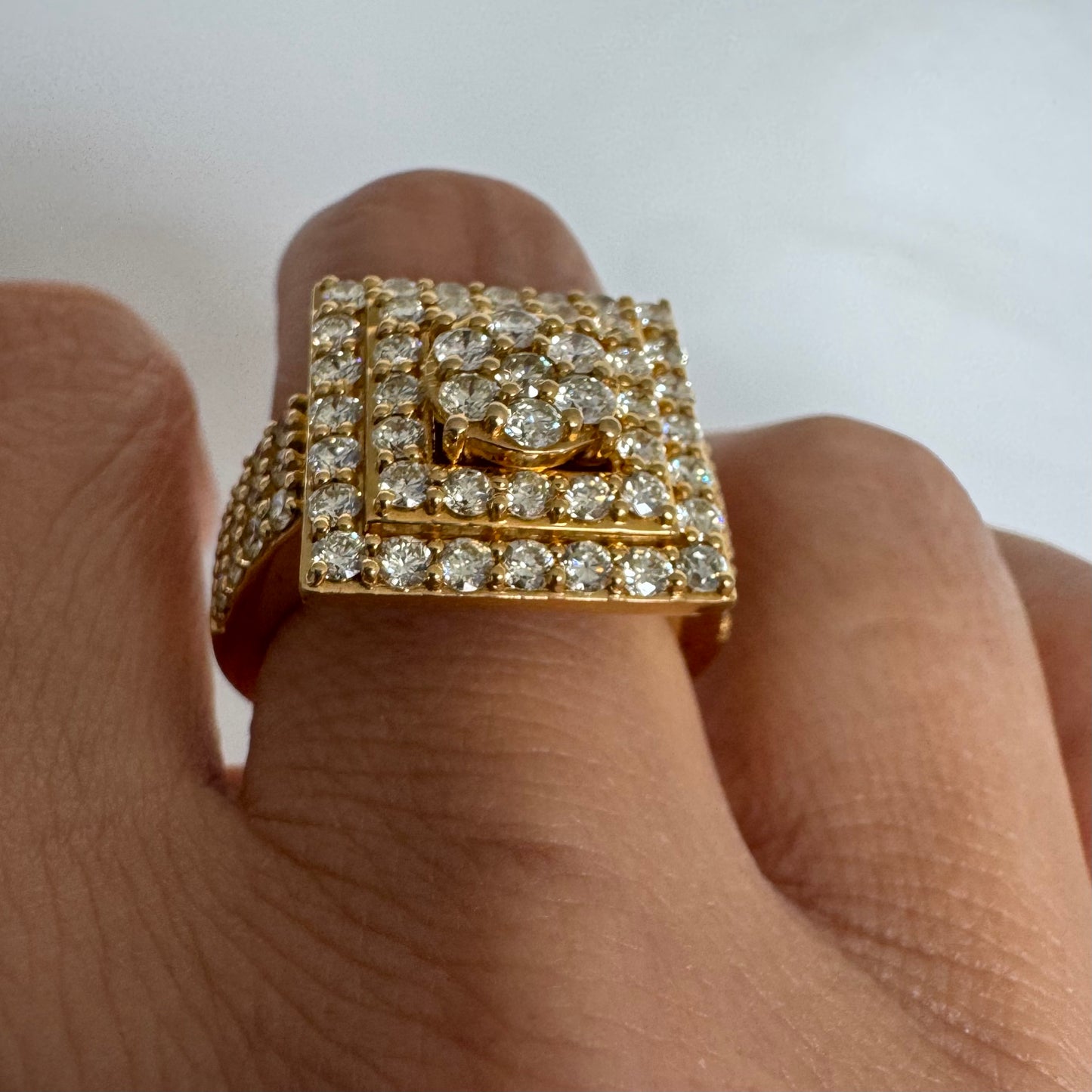 10K gold ring featuring a bold geometric design beautifully set with sparkling Diamonds