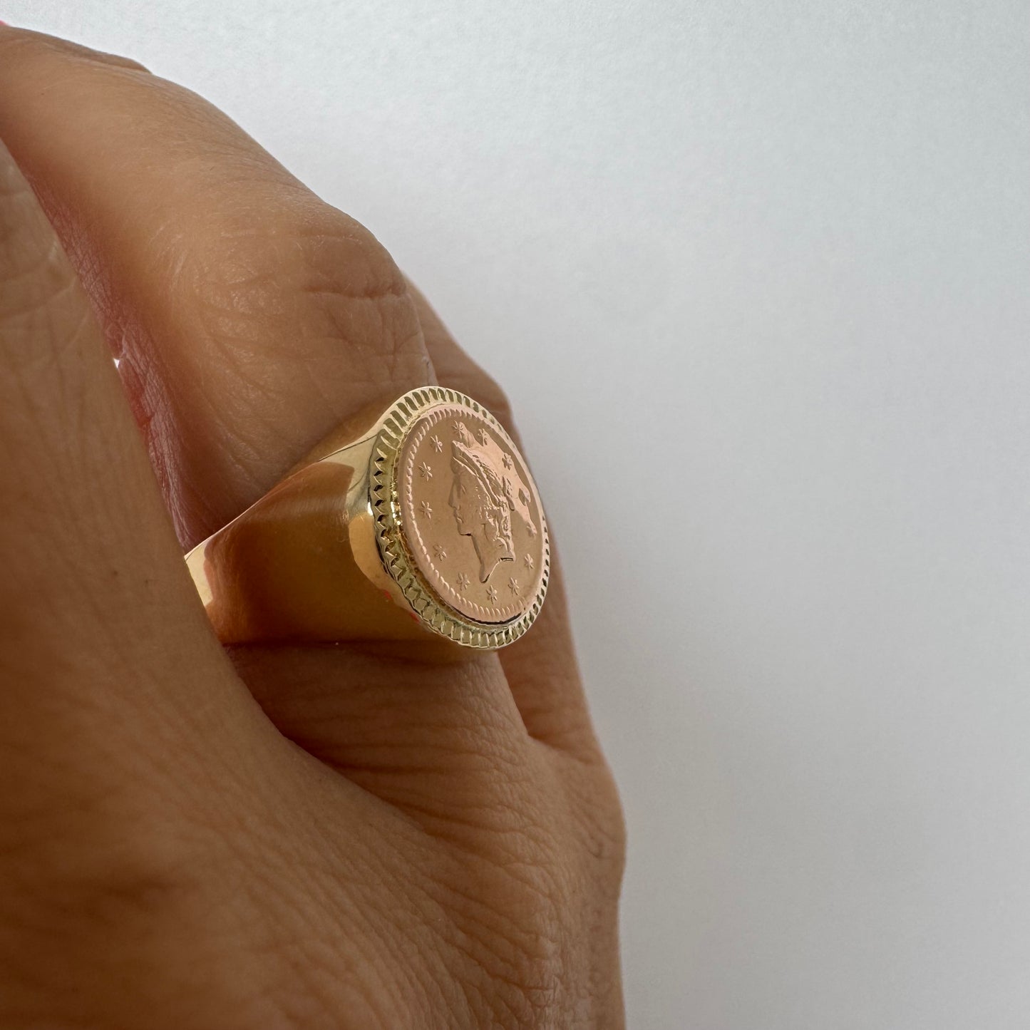 18K gold coin ring set with an authentic 22K gold coin at the center.