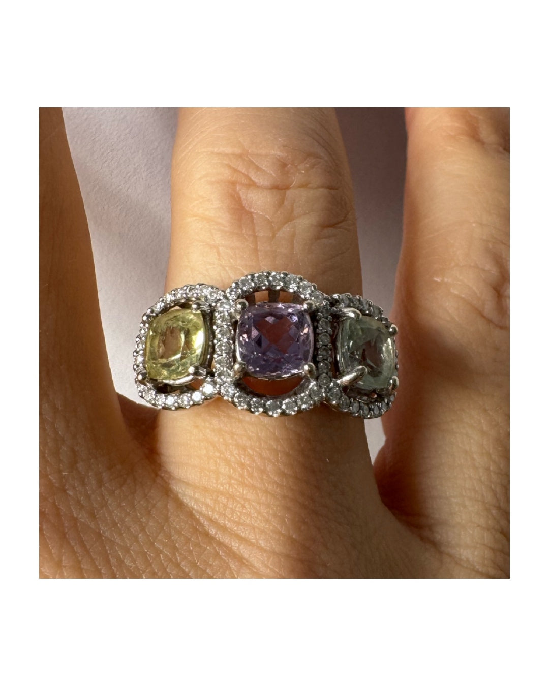 18K gold ring set with three pastel gemstones in soft shades of lilac, yellow and light gray