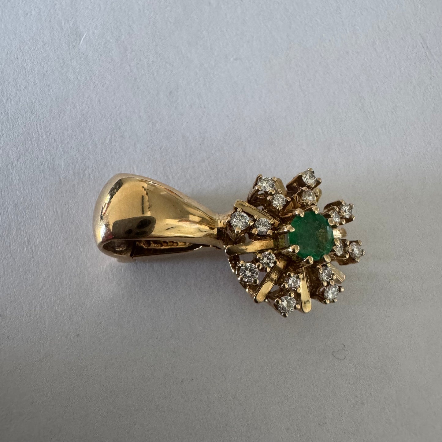14K gold pendant centered with a Emerald and surrounded by a halo of sparkling Diamonds