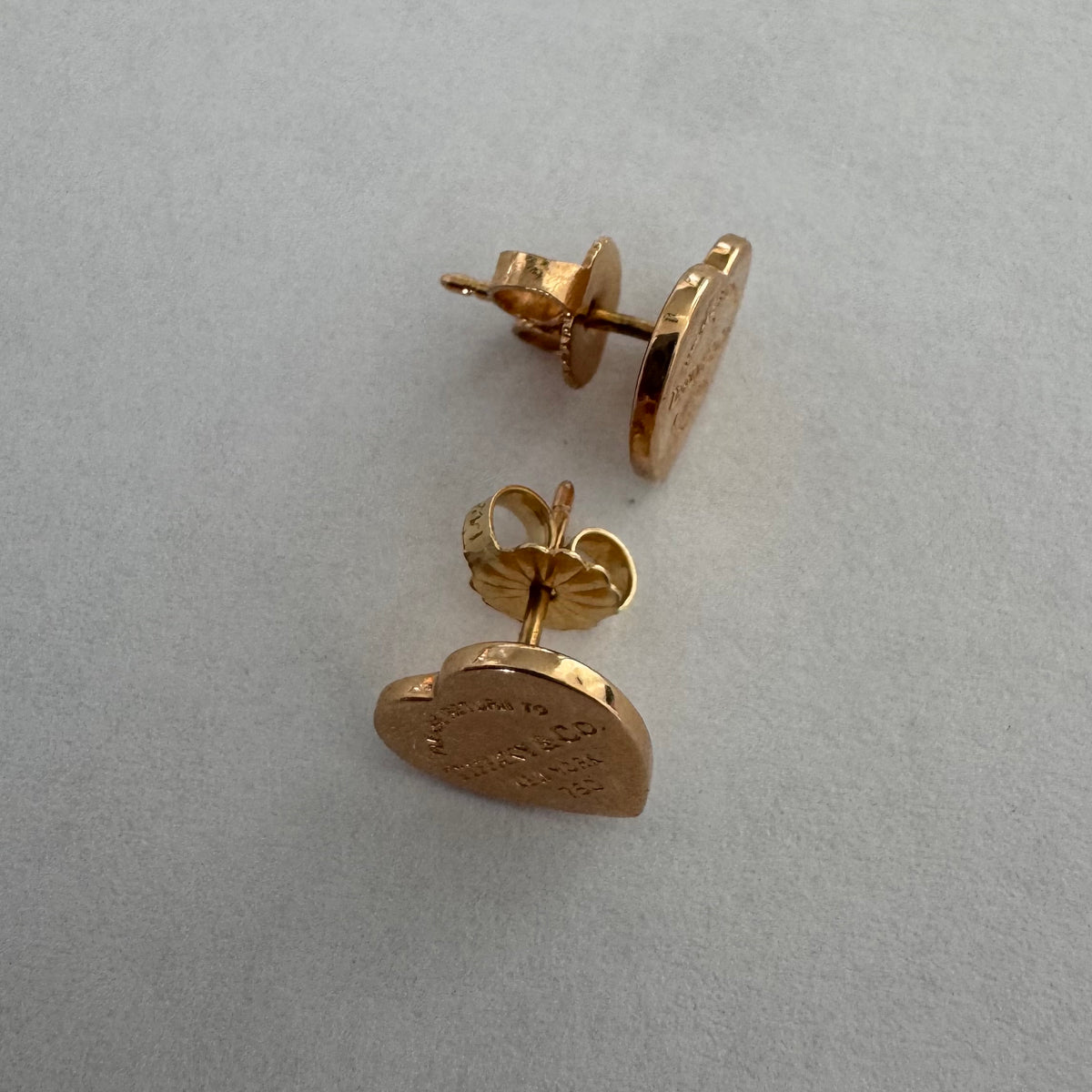 עגילים צמודים של Tiffany &amp; Co. עשויים זהב 18 קראט (750), בעיצוב לב אייקוני עם חריטת “Please Return to Tiffany & Co. New York”. 