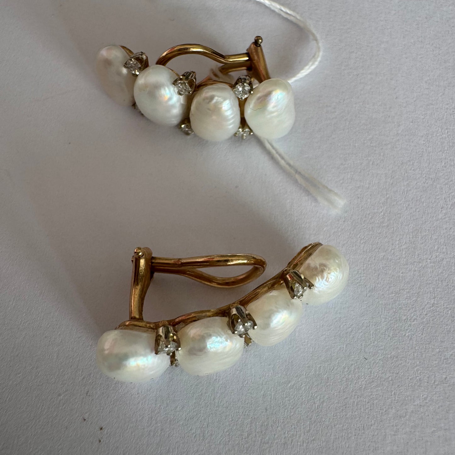 14K gold clip-on earrings set with Pearls accented by sparkling Diamonds between each pearl