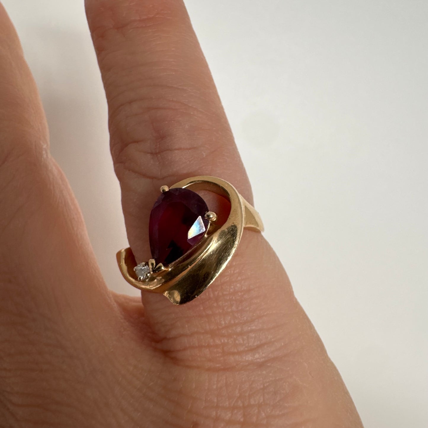 14K gold sculptural open ring set with a pear-cut pink Tourmaline, accented by a small Diamond.