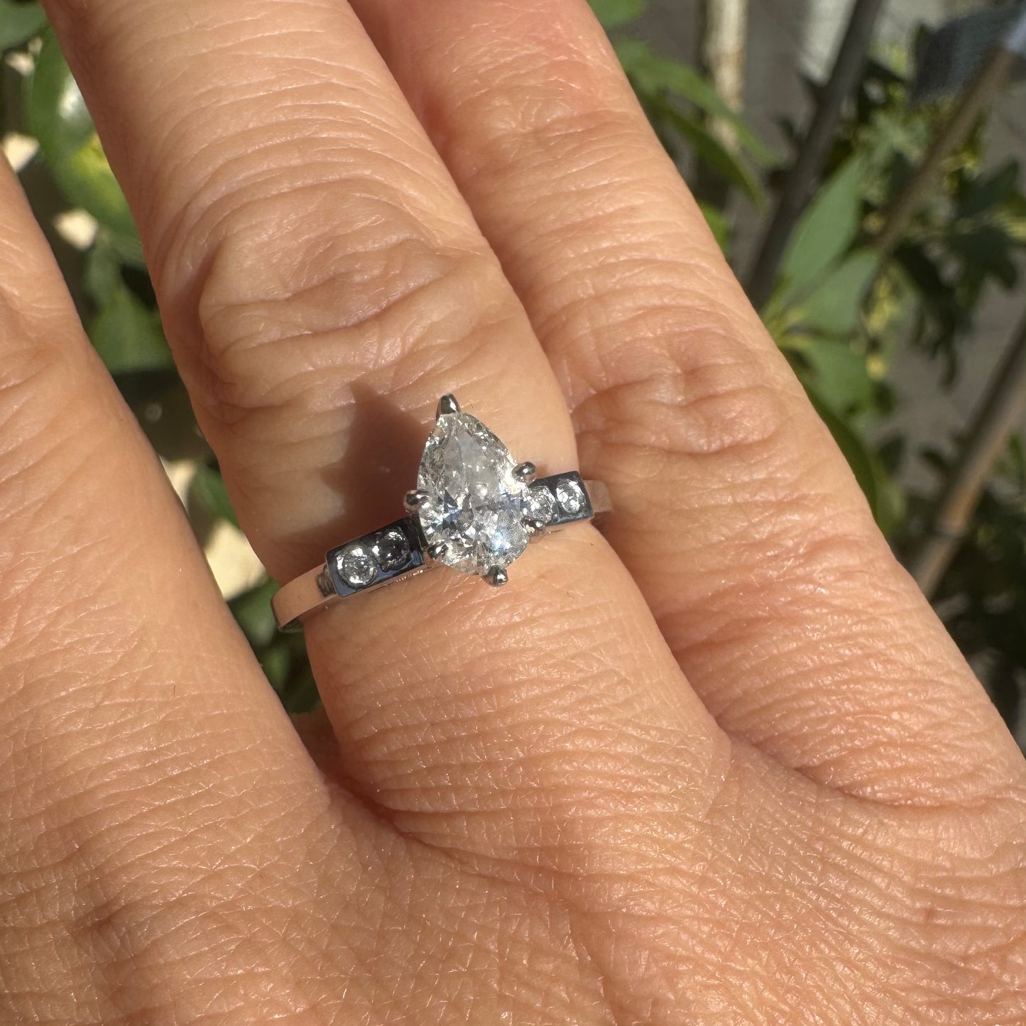 Platinum ring set with one center Pear cut Diamond & side Diamonds