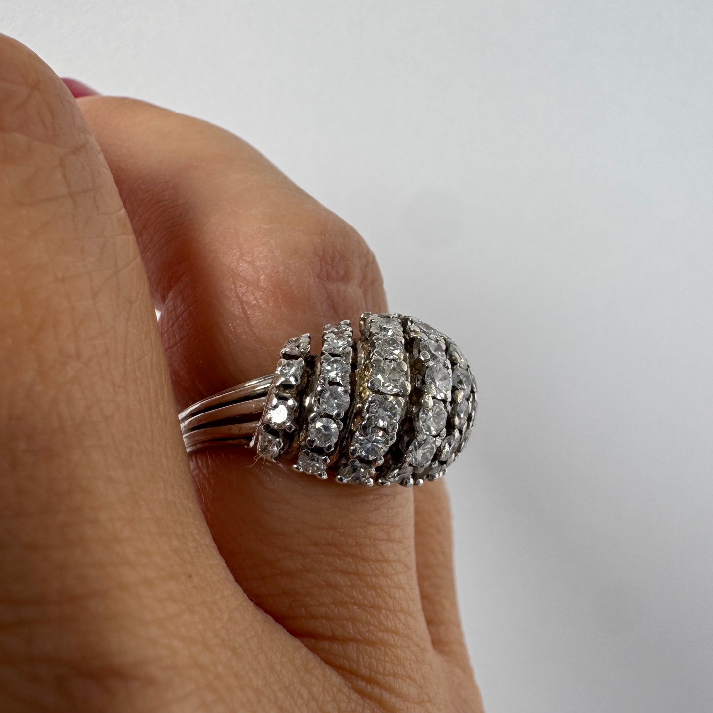 18K gold diamond ring with curved rows of brilliant stones.