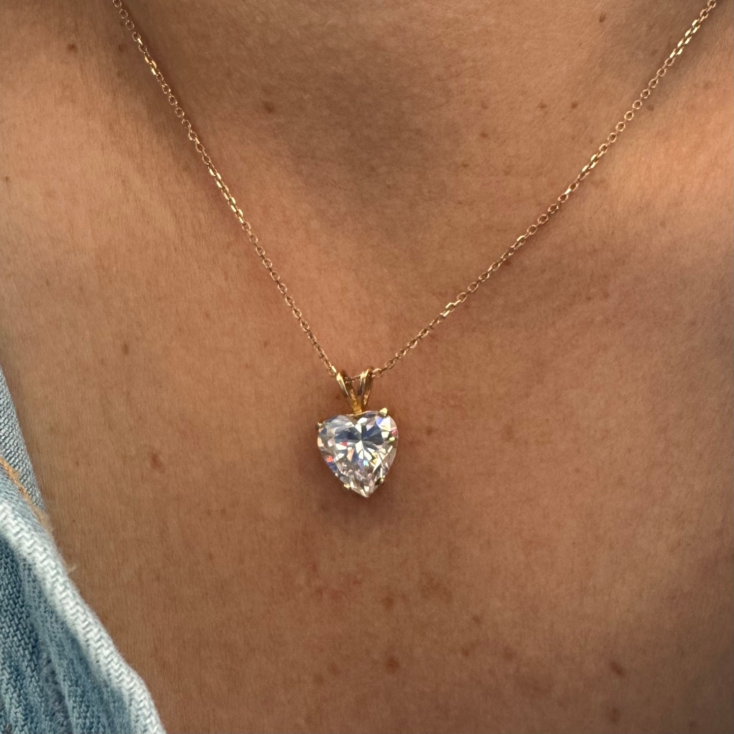 14K gold Heart Pendant set with a brilliant heart-cut clear stone.