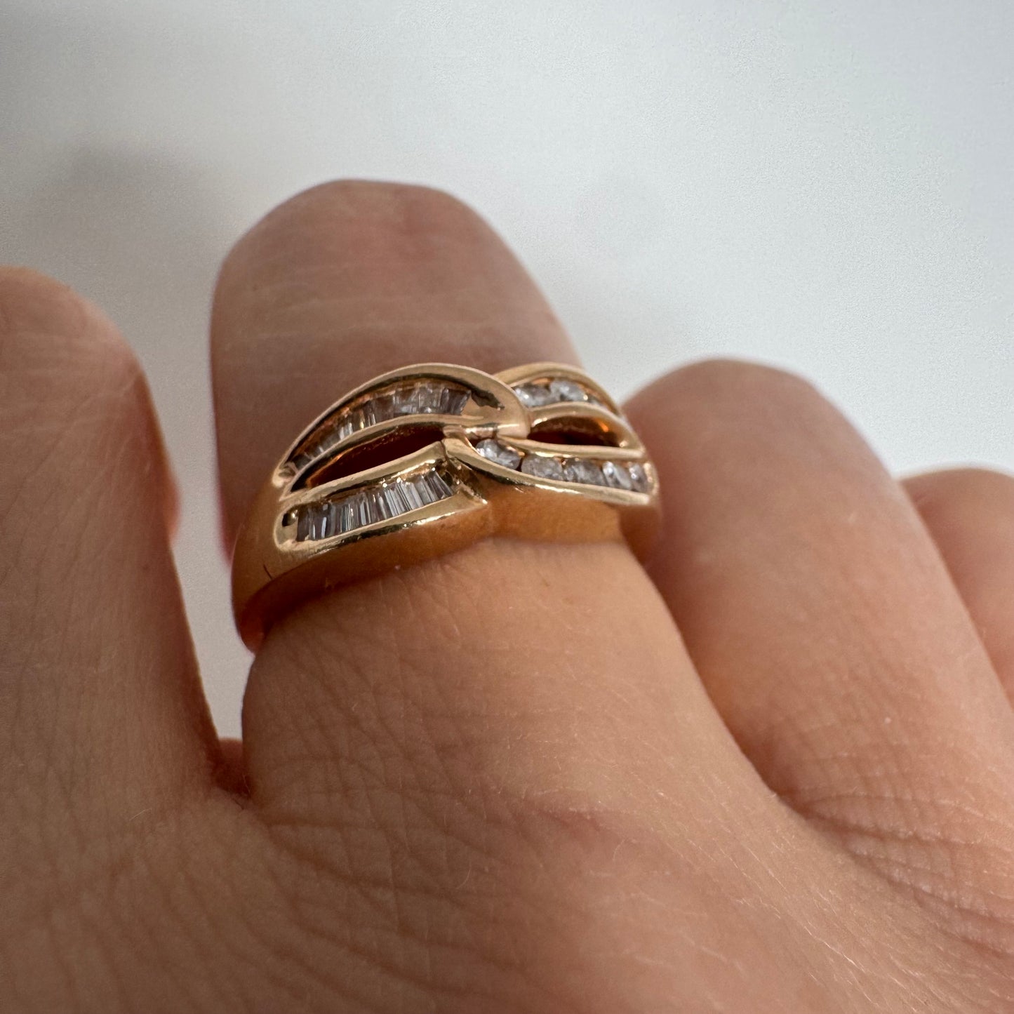 14K gold open infinity ring set with round and baguette-cut Diamonds.