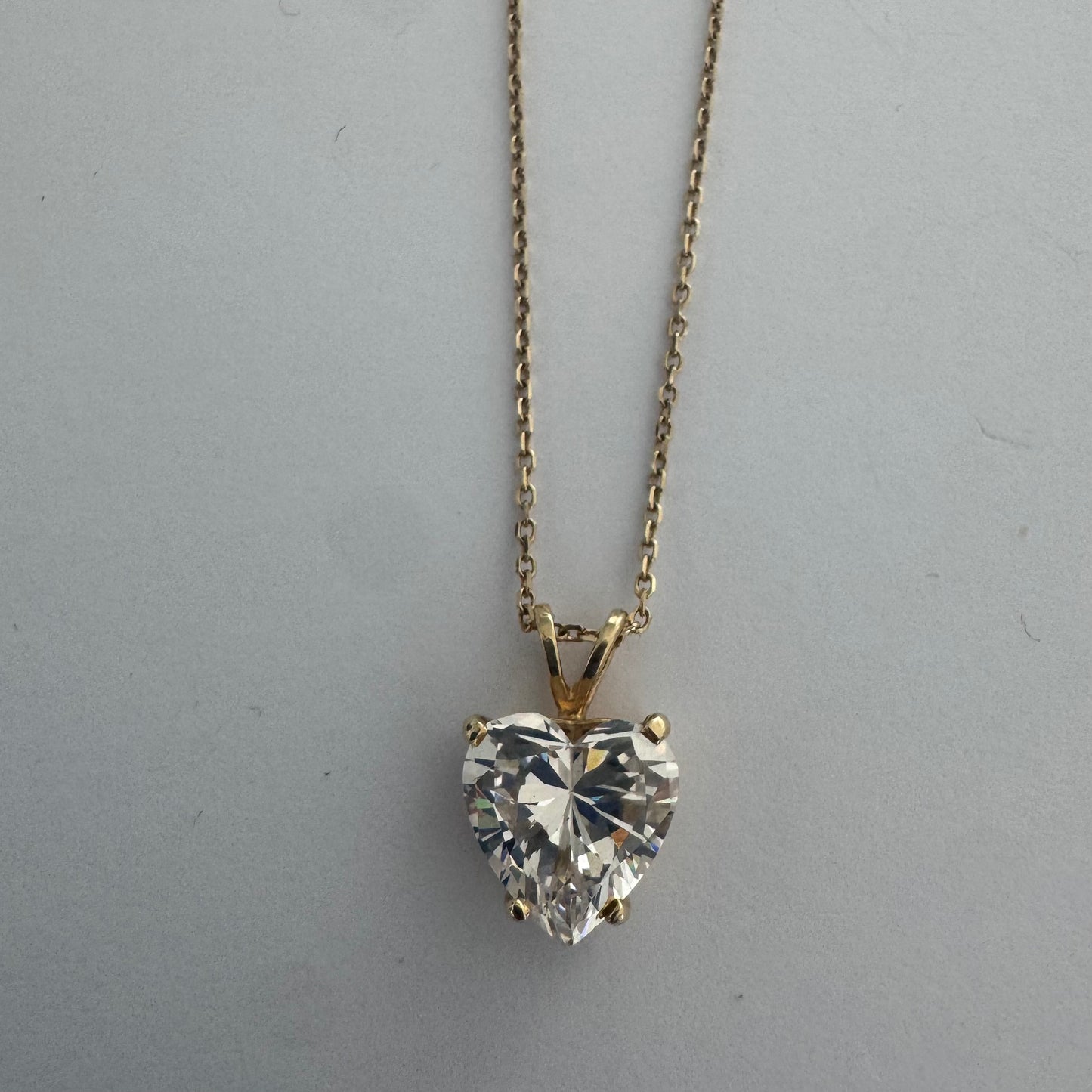 14K gold Heart Pendant set with a brilliant heart-cut clear stone.