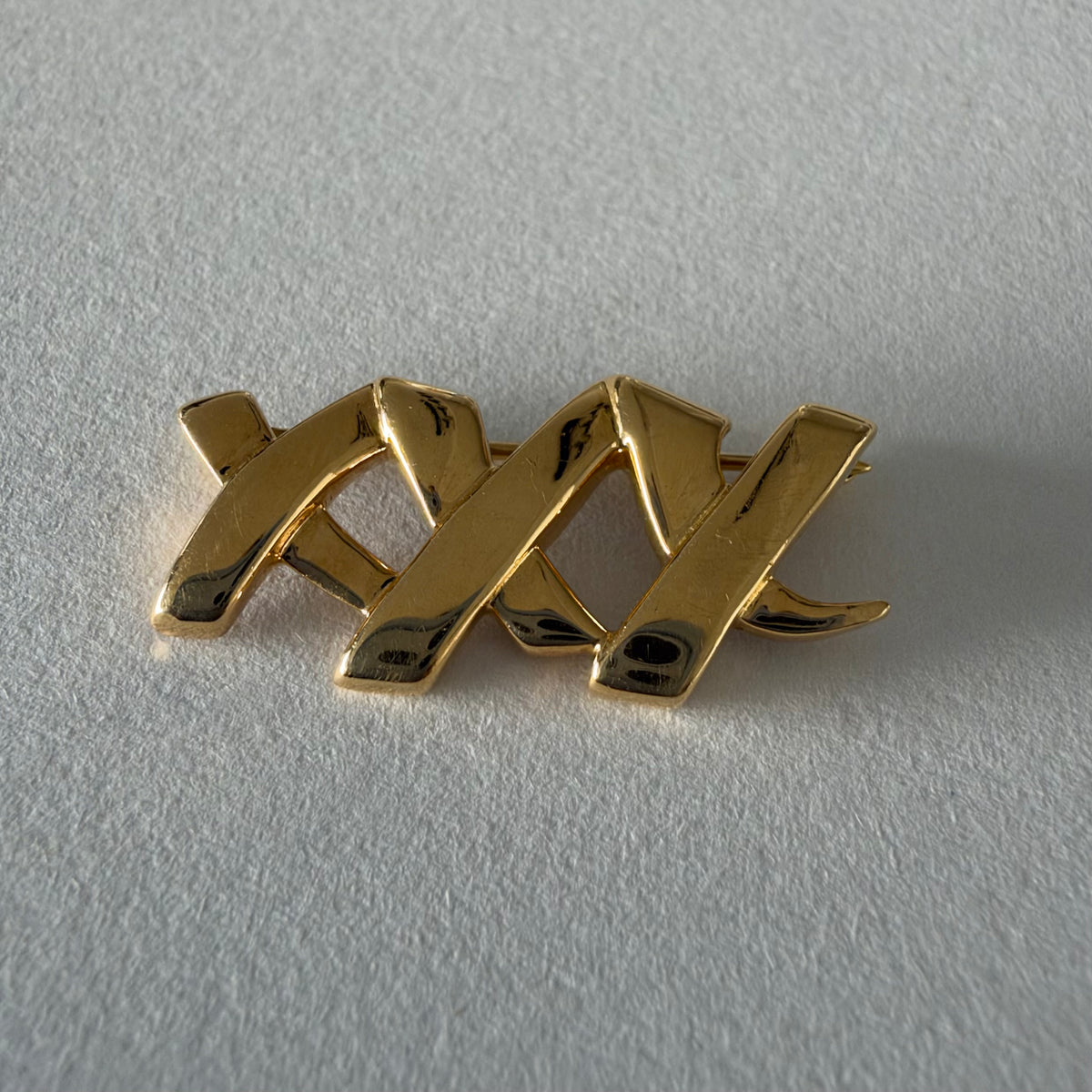 A Tiffany & Co. 18K gold brooch designed by Paloma Picasso from the iconic Graffiti Collection.