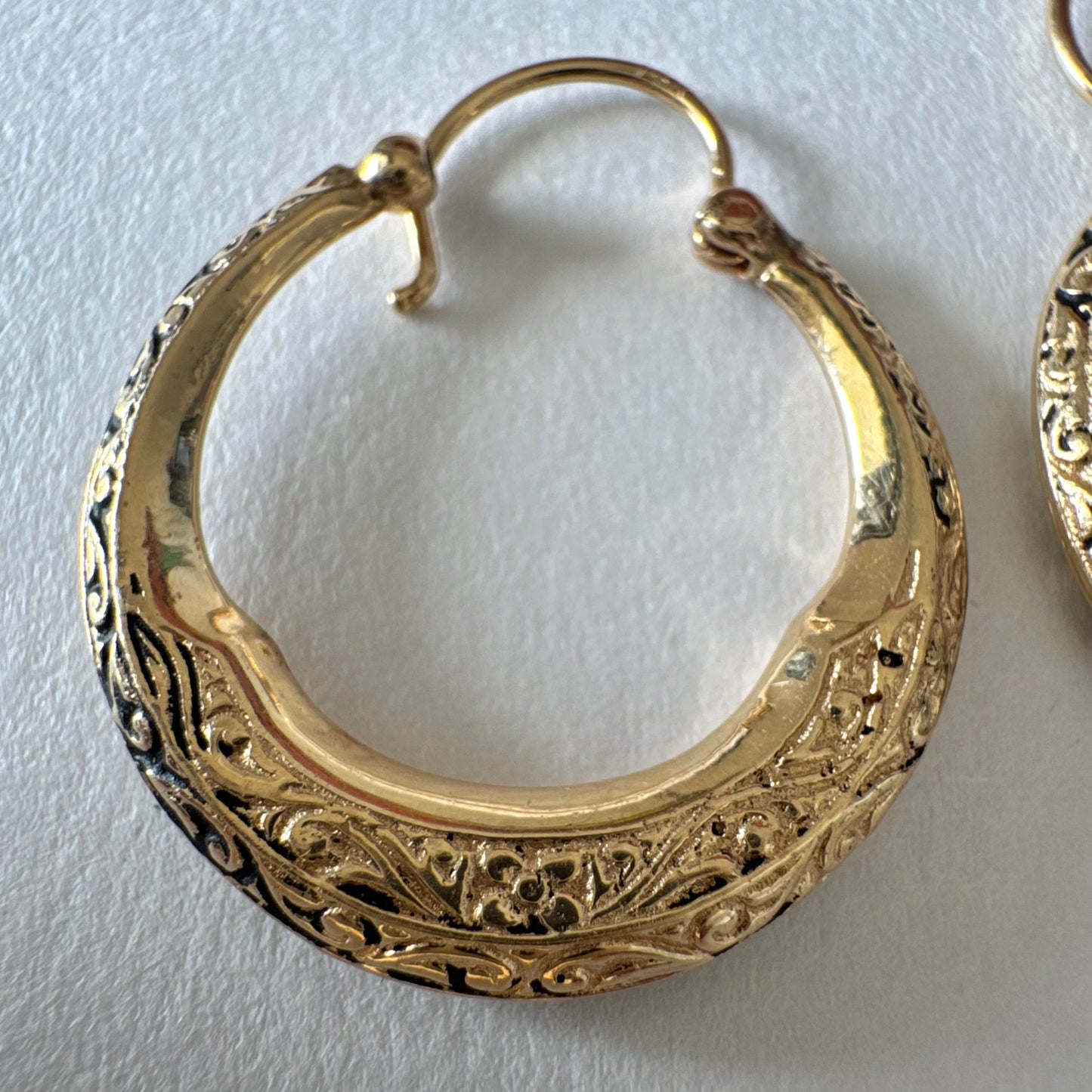 14K gold hoop earrings featuring an intricate openwork design and beautifully detailed engraving