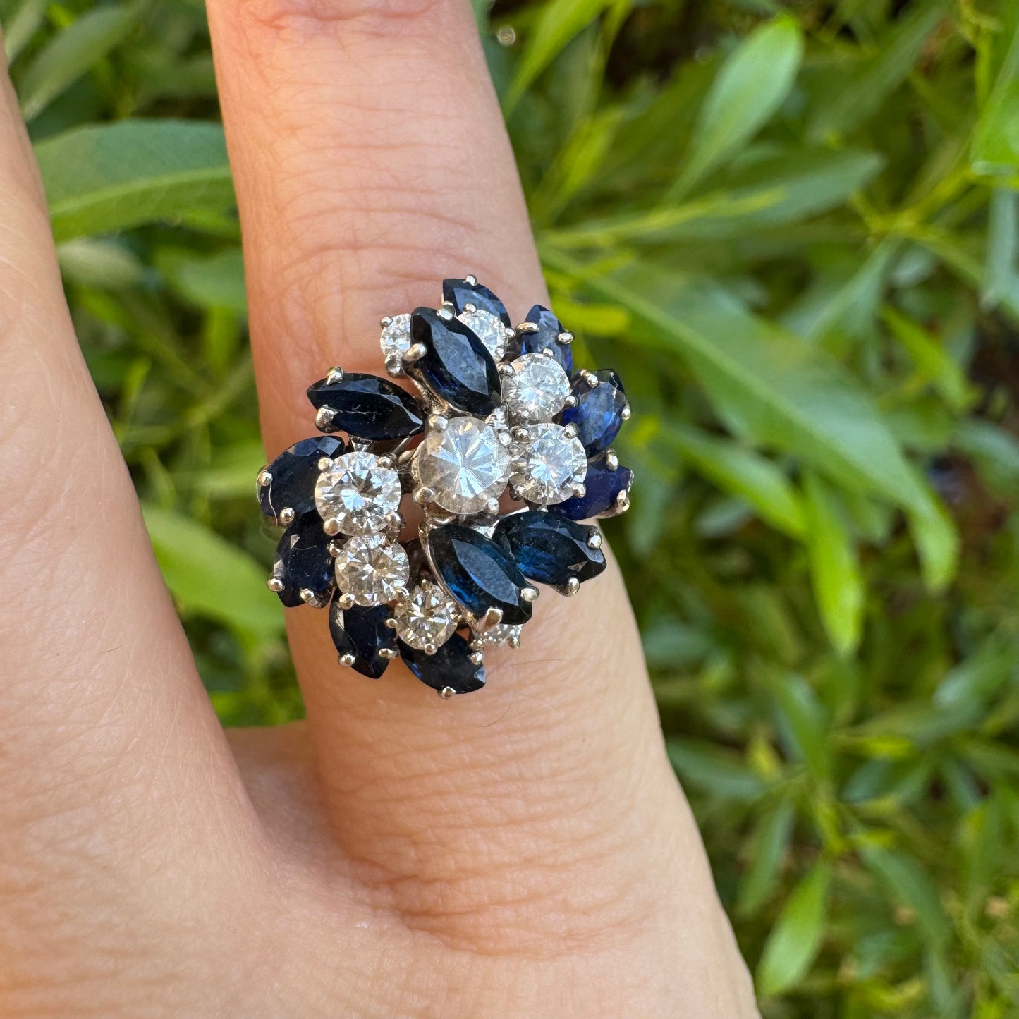 18K white gold ring, set with marquise-cut blue Sapphires and round Diamonds, in a classic cluster design.