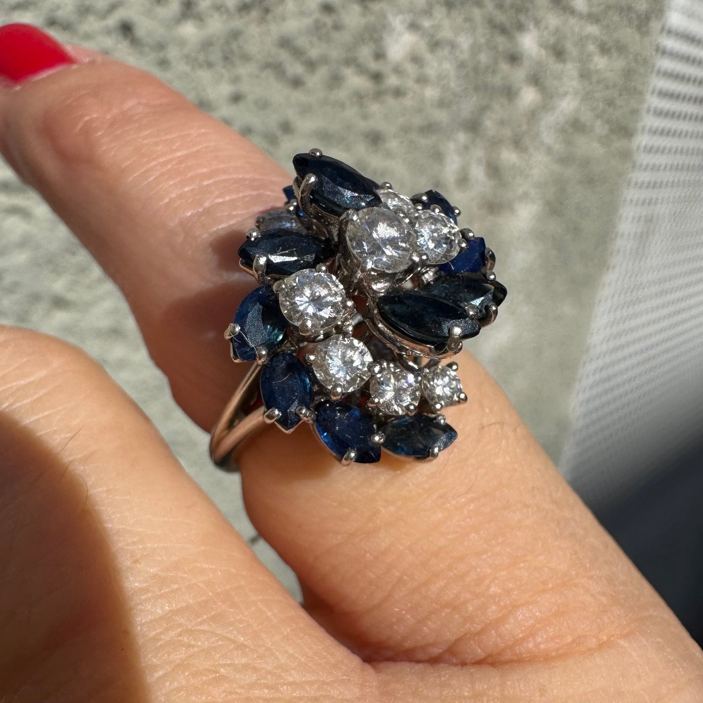 18K white gold ring, set with marquise-cut blue Sapphires and round Diamonds, in a classic cluster design.