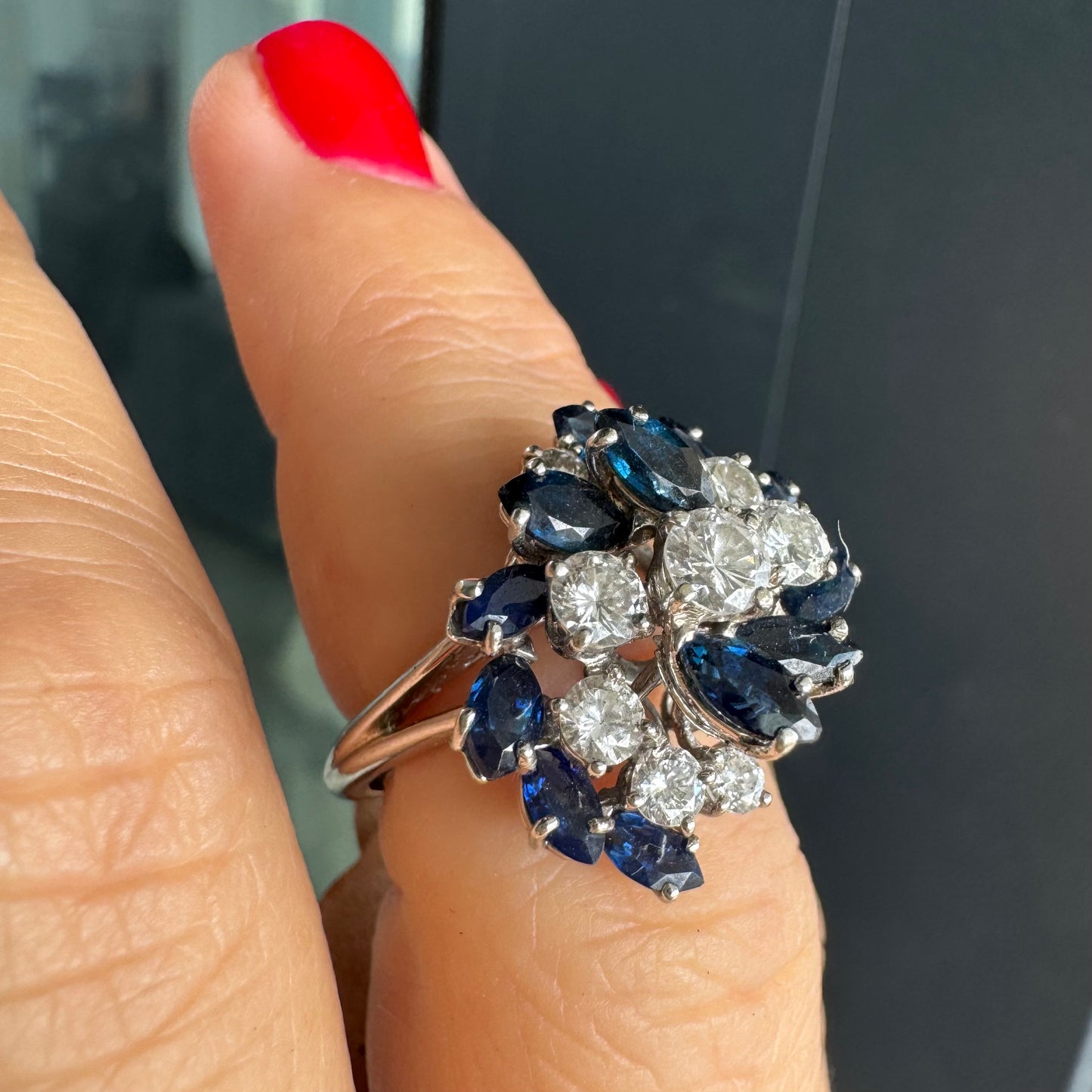 18K white gold ring, set with marquise-cut blue Sapphires and round Diamonds, in a classic cluster design.