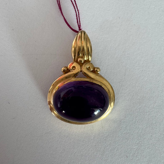 14K gold pendant set with a large cabochon Amethyst