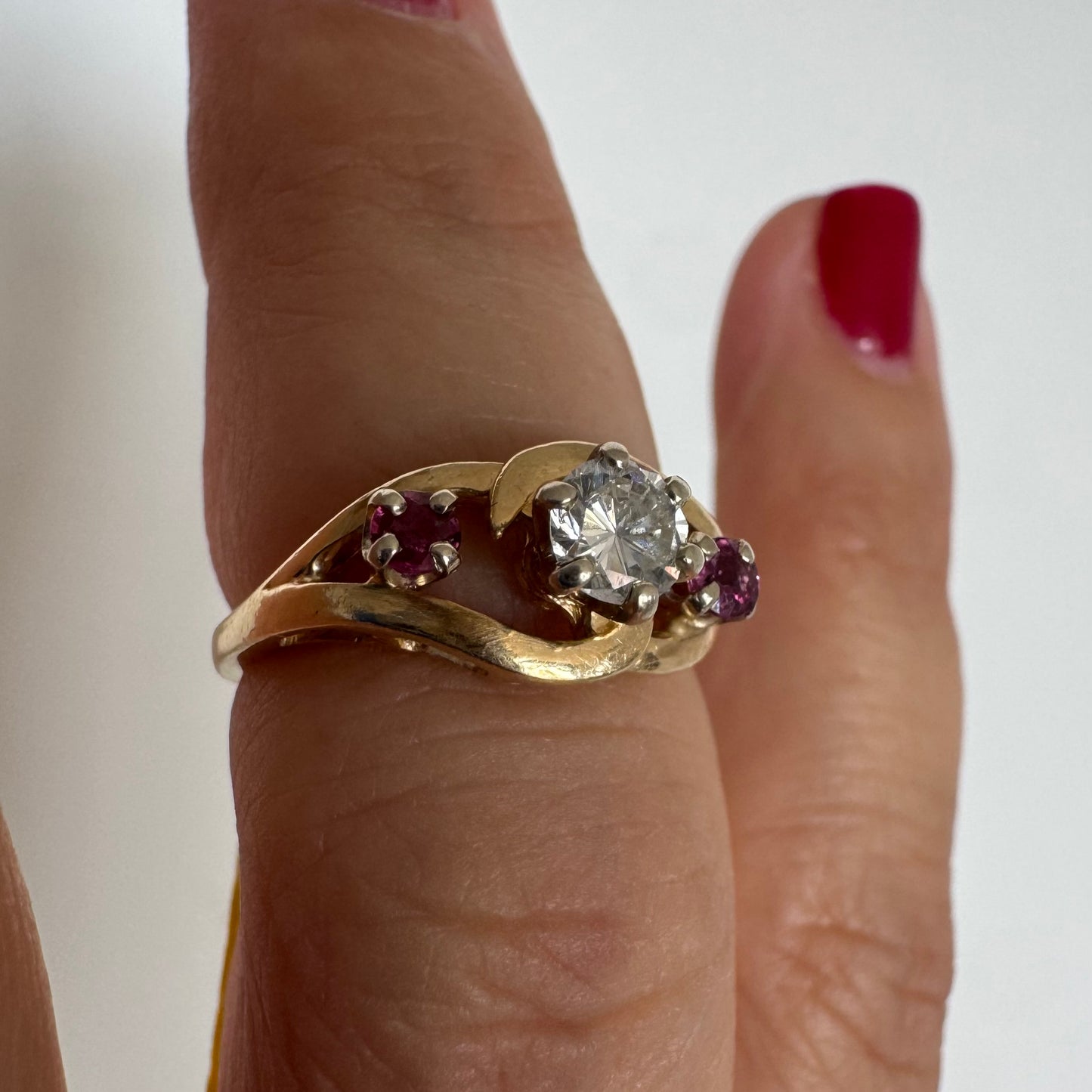 14K gold ring set with a sparkling central Diamond & Ruby side stones
