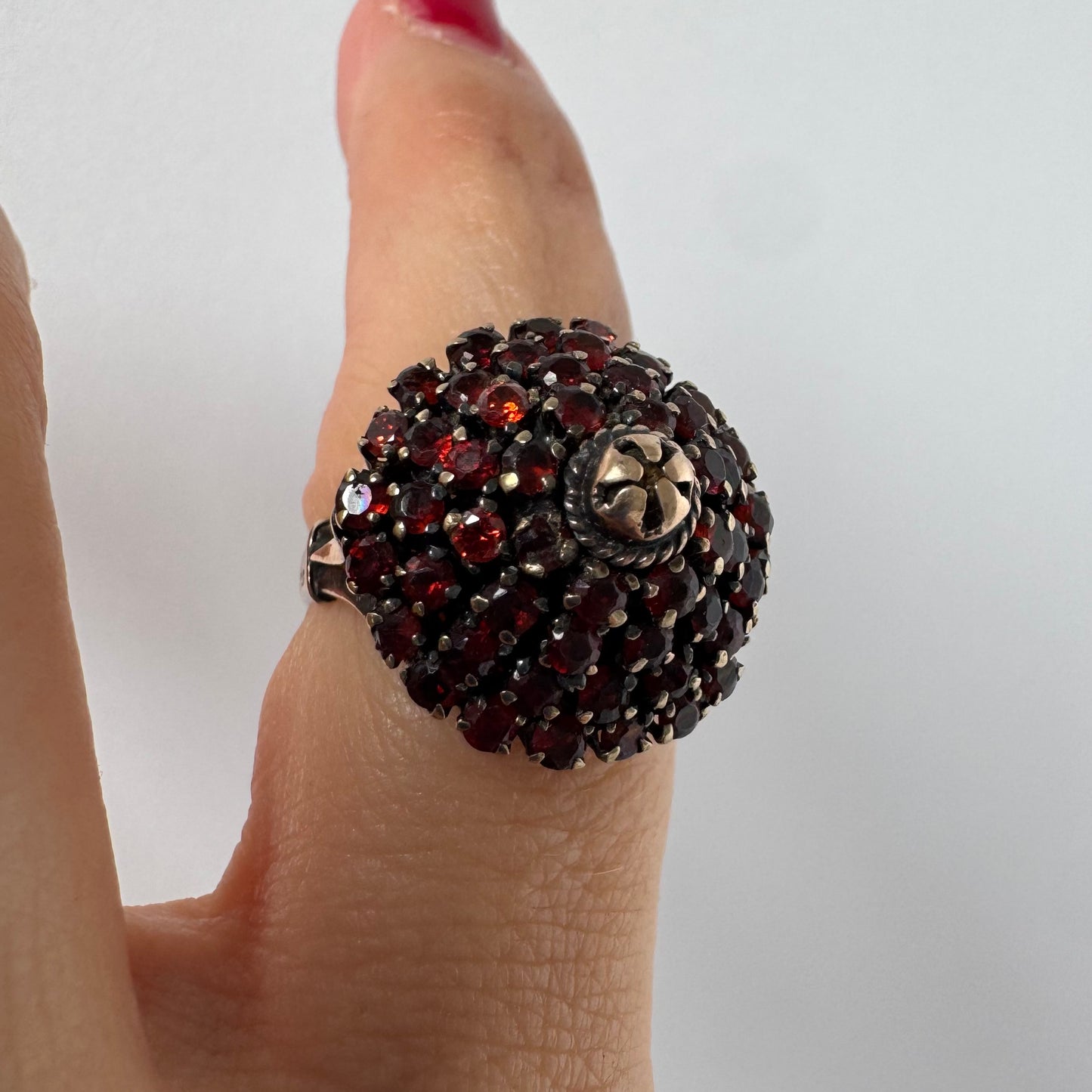 10K gold statement ring designed as a bold floral cluster set with Garnets