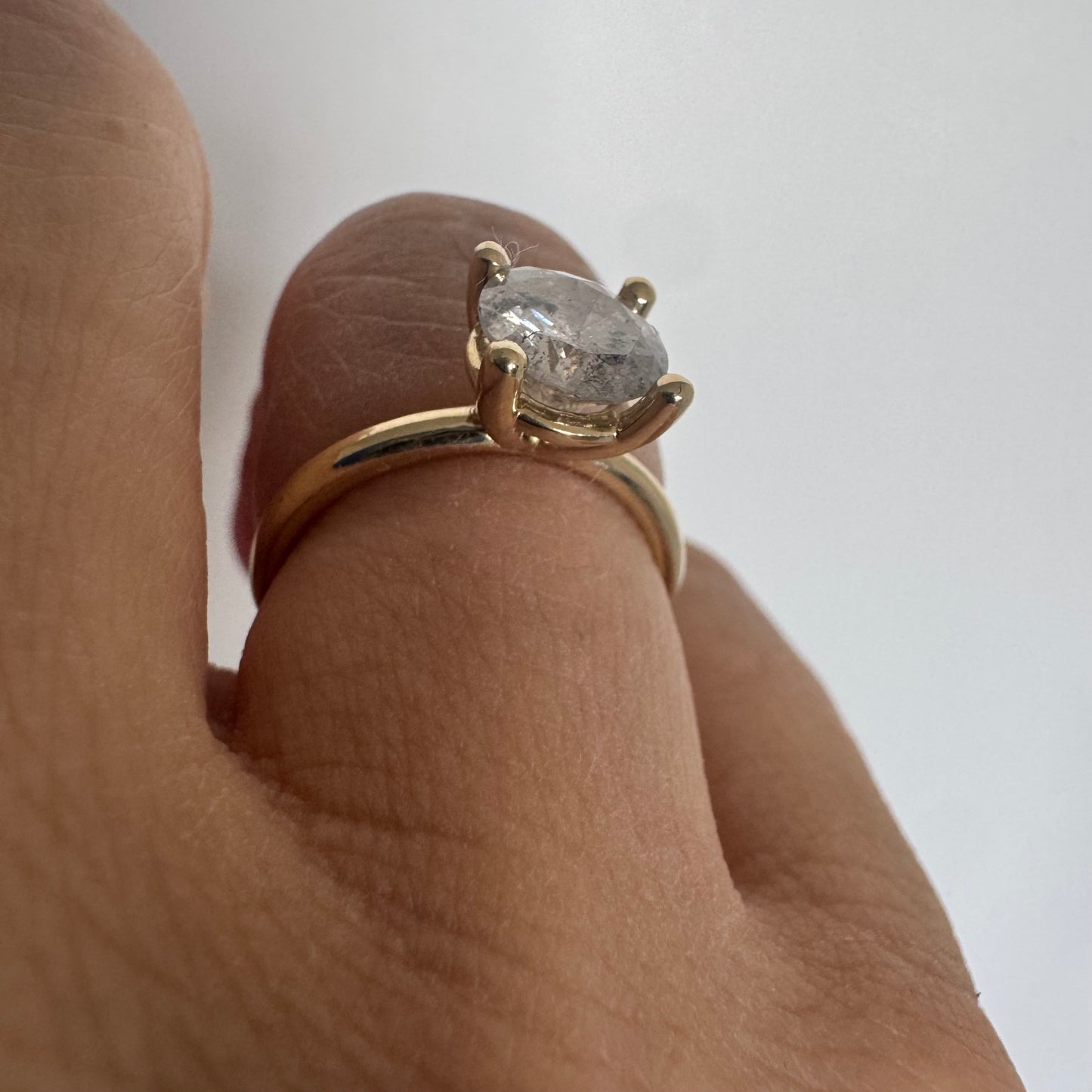 14K gold solitaire ring set with a central round Diamond