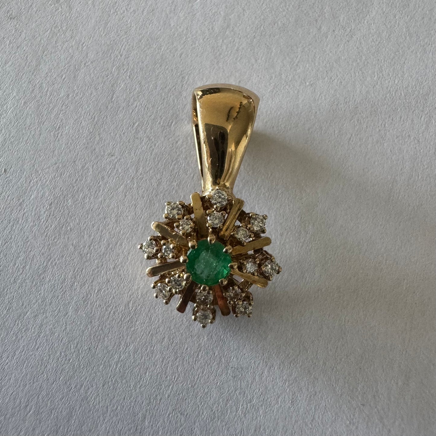 14K gold pendant centered with a Emerald and surrounded by a halo of sparkling Diamonds